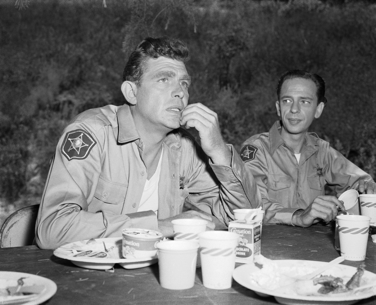 Andy Griffith and Don Knotts relax after a meal on the set of 'The Andy Griffith Show,' 1960