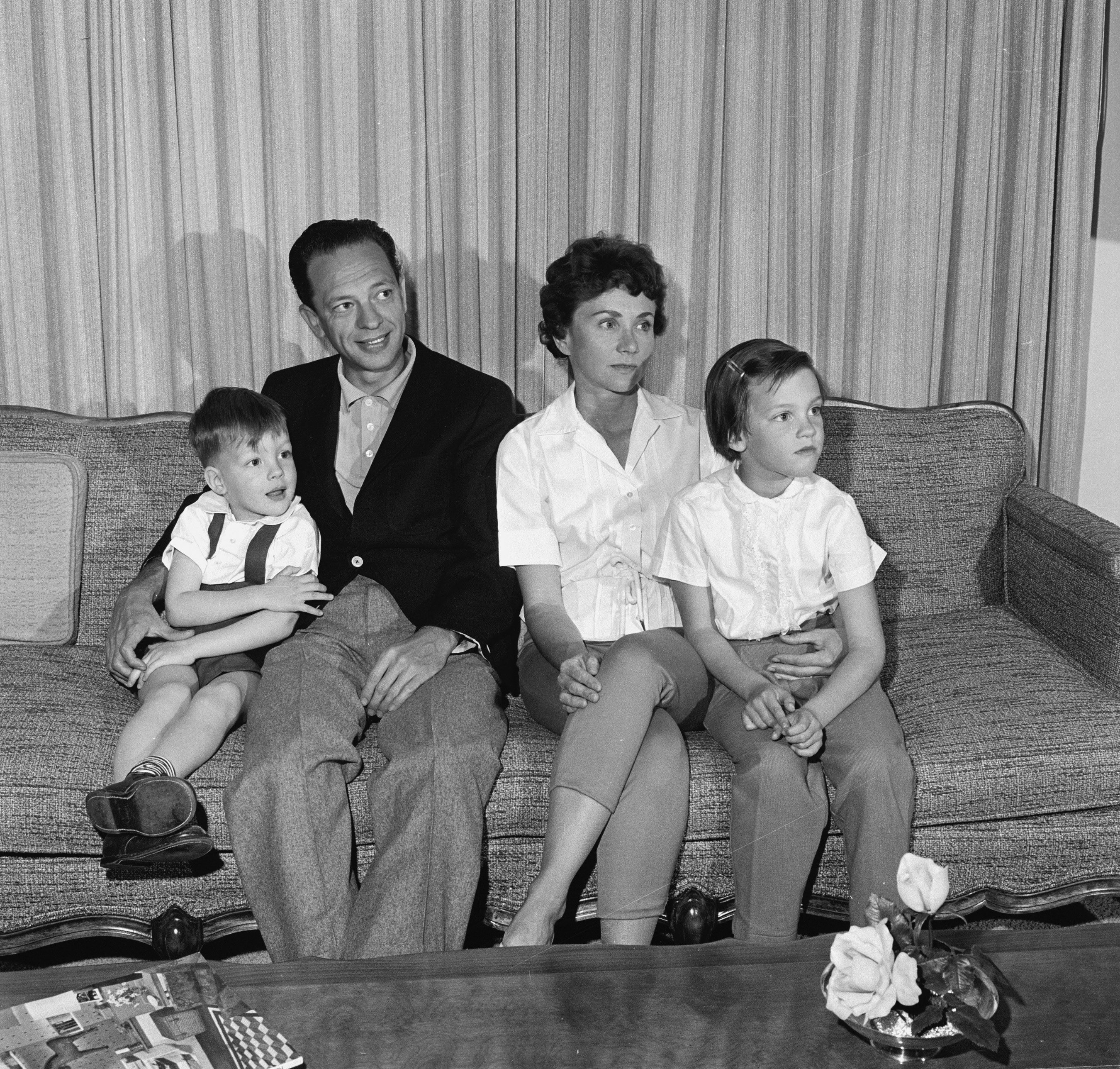 Don Knotts,his wife Kay and their two children sit for a photo on a couch, 1961