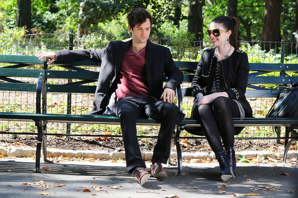 Michelle Trachtenberg and Penn Badgley are seen on set of 'Gossip Girl' sitting on a park bench