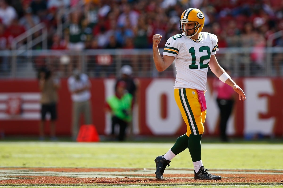 Green Bay Packers quarterback Aaron Rodgers fist pumps in the air during game