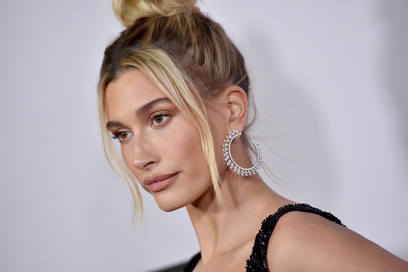 Hailey Bieber looking on