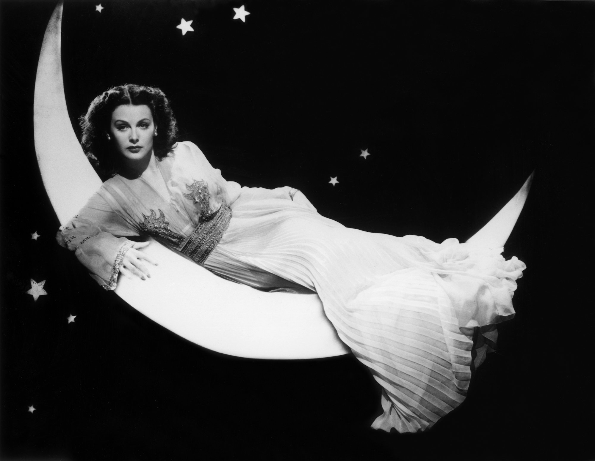 Hedy Lamarr lying on a half moon