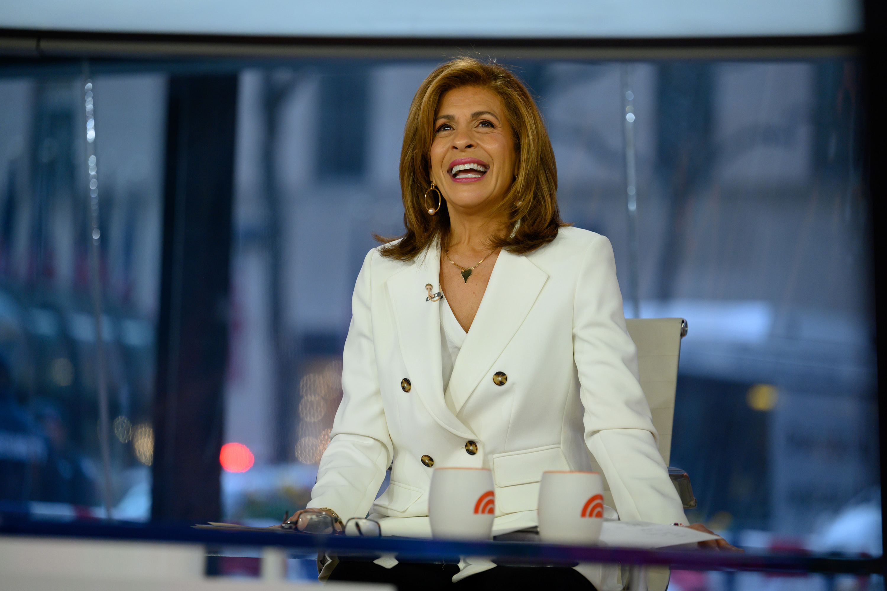 Hoda Kotb smiling at the desk of the 'Today Show' 