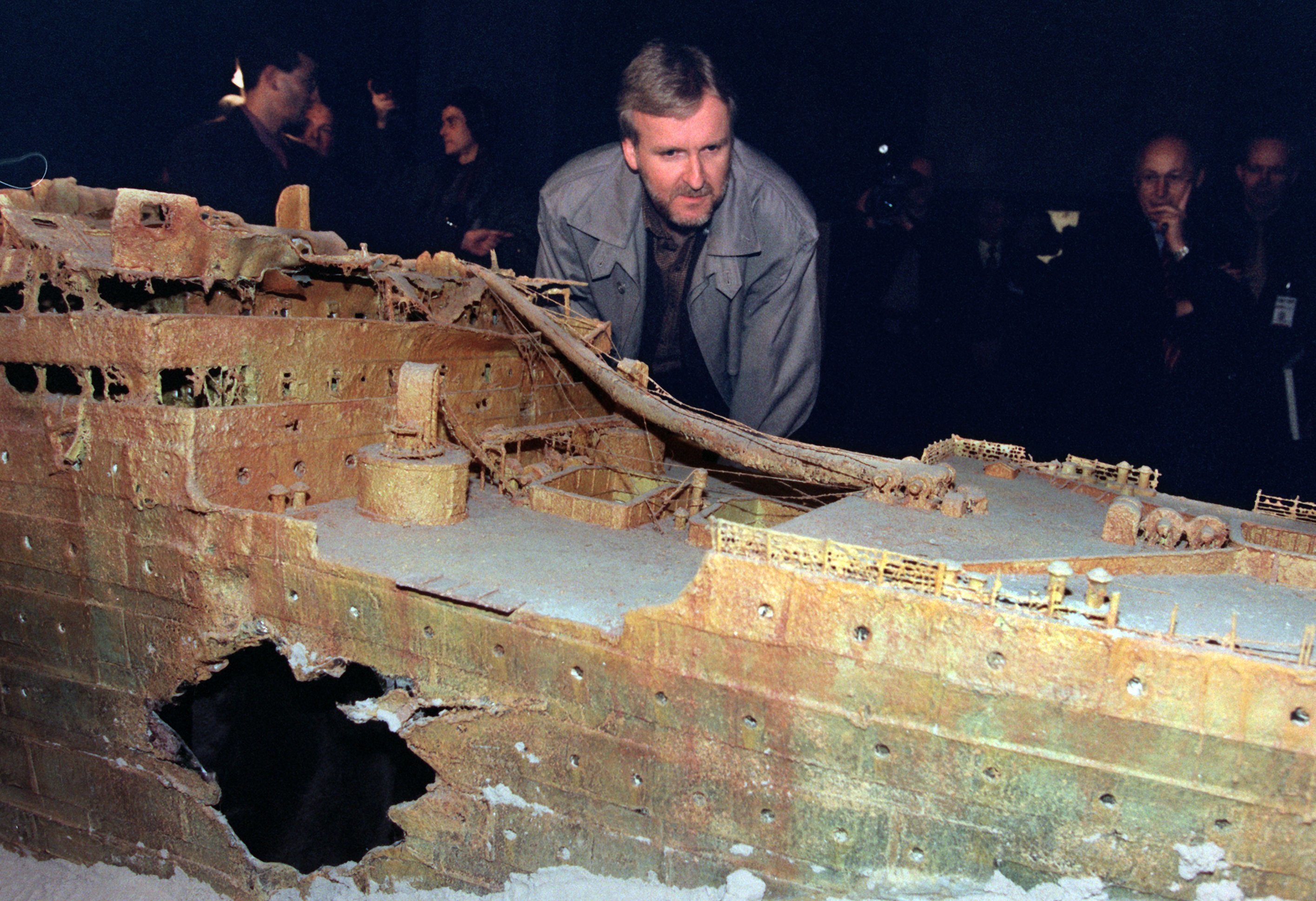 James Cameron looks at a model of the Titanic