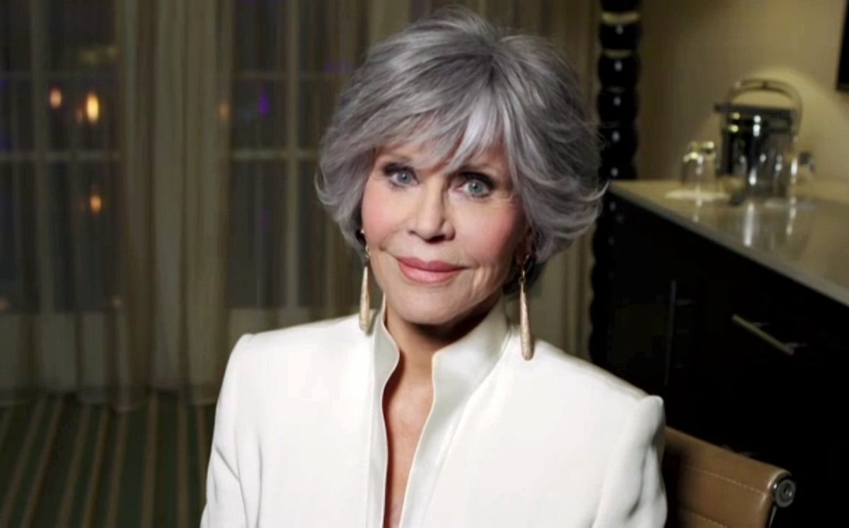 Jane Fonda wearing a white suit and dangling earrings