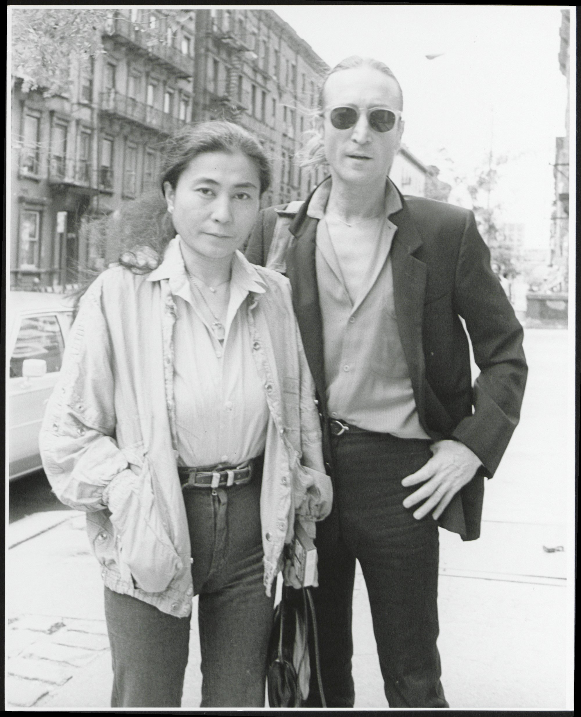 John Lennon and Yoko Ono standing on the street