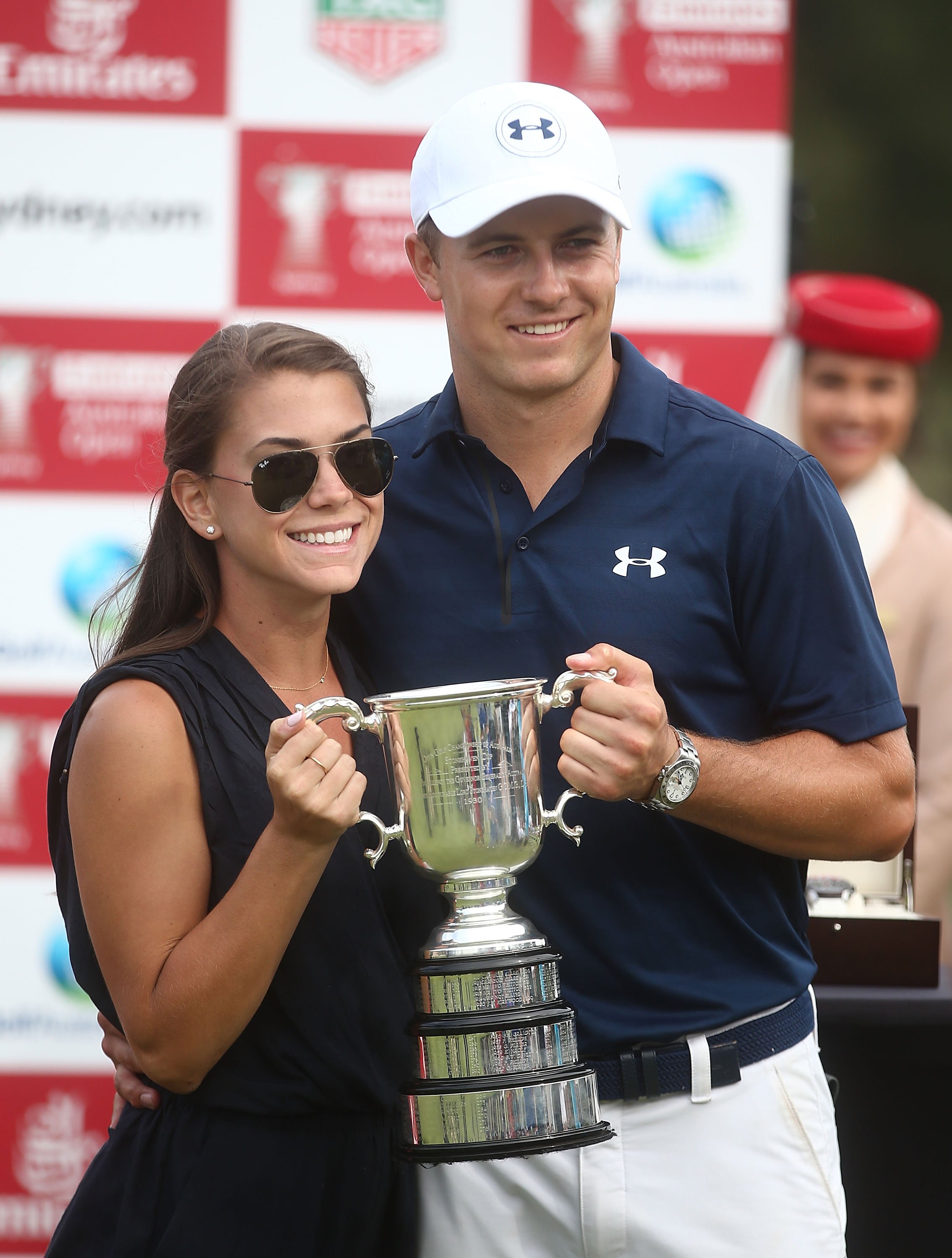 Jordan Spieth and Annie Verret pose holding the Stonehaven trophy after he won the 2016 Australian Open