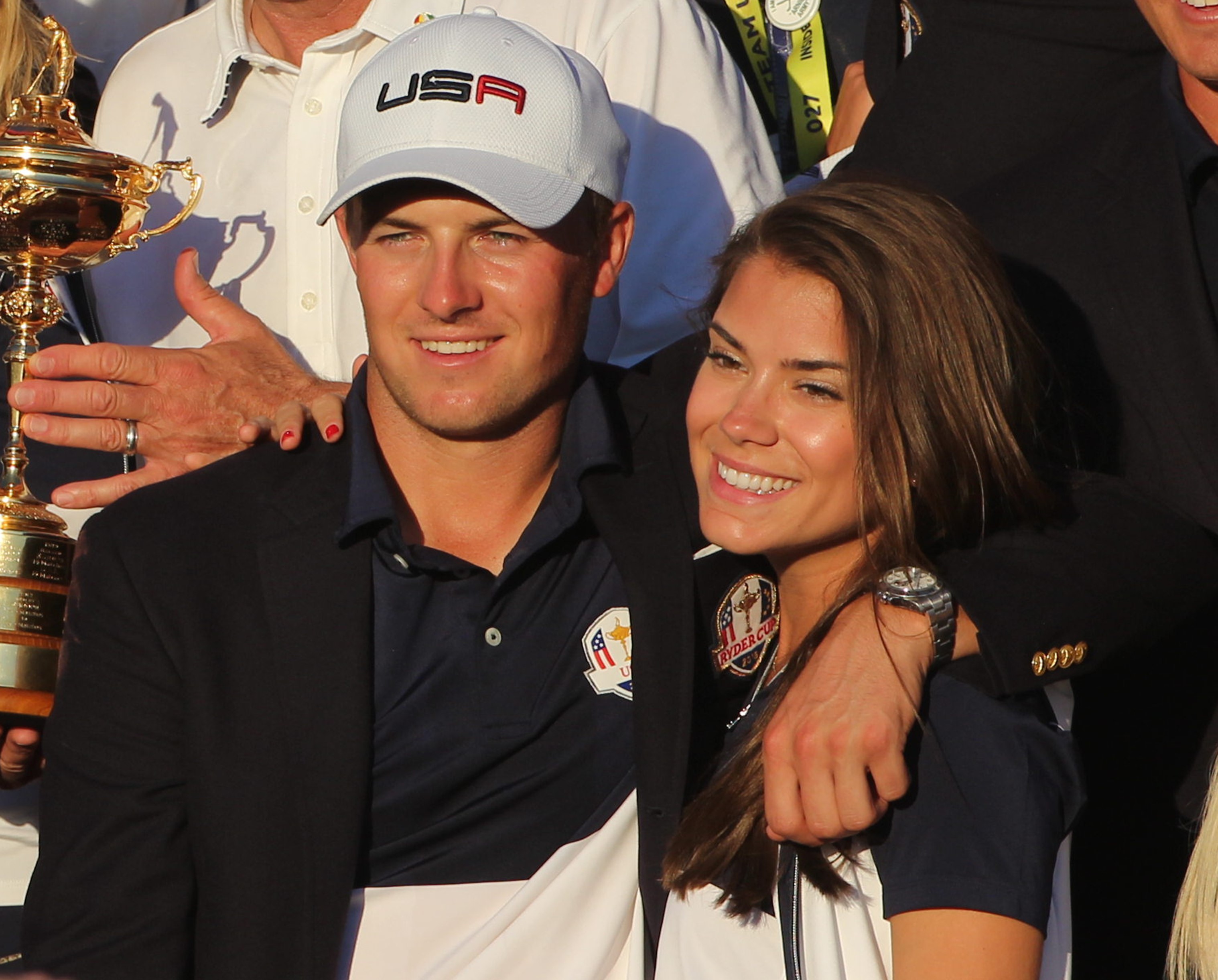 Jordan Spieth with his arm around his partner Annie Verret as the U.S. team players and their spouses celebrate with the Ryder Cup