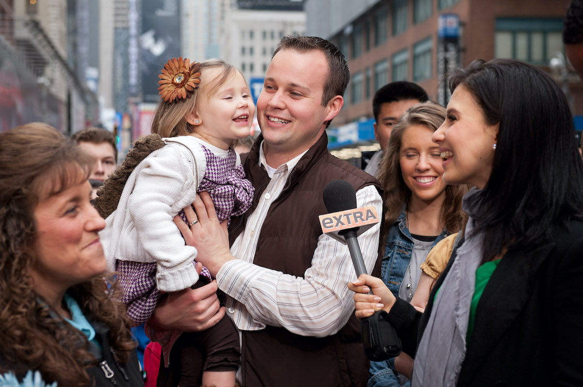 Josh Duggar holds his daughter in 2013