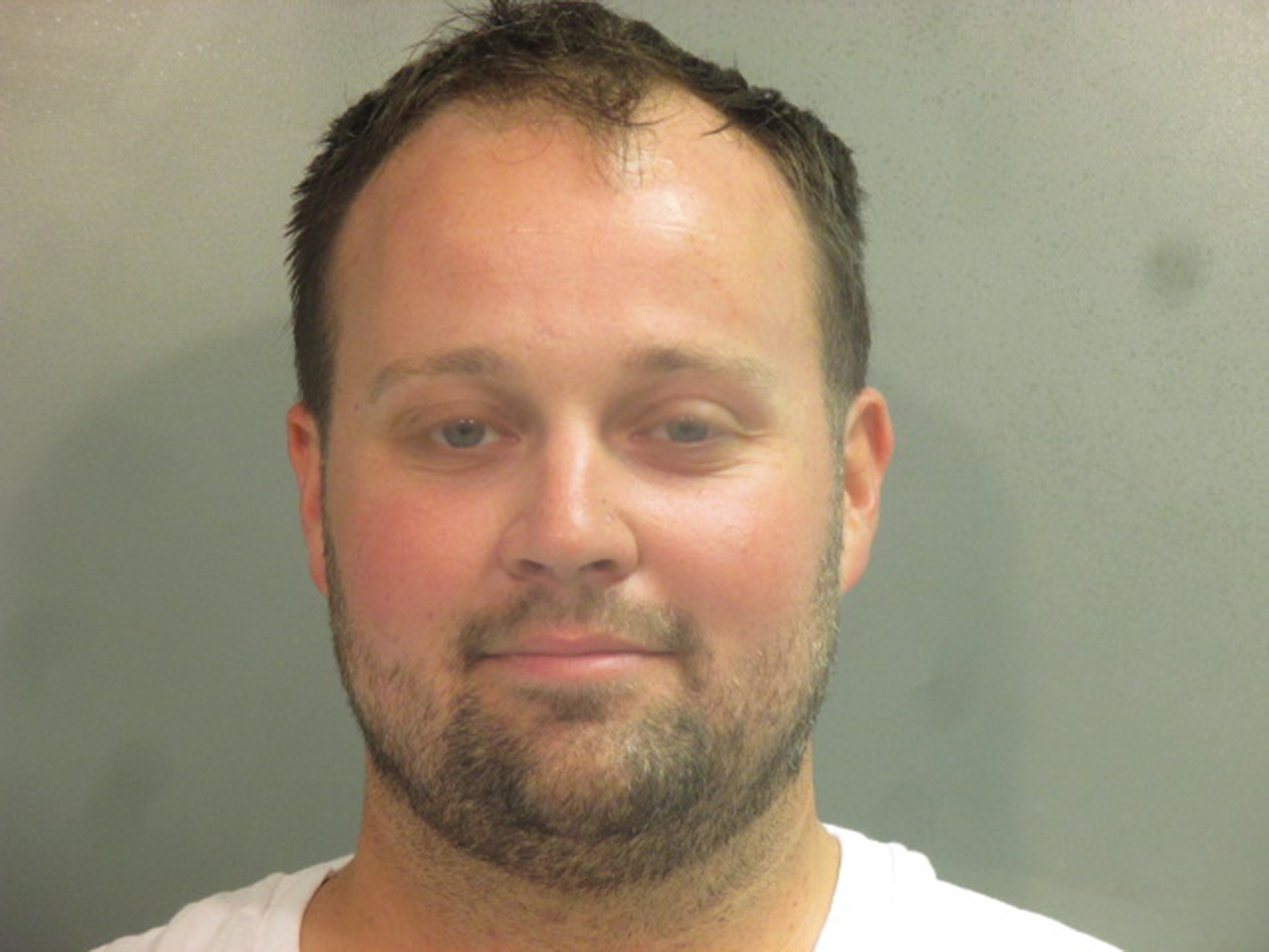 In this handout photo provided by the Washington County Sheriff’s Office, former television personality on "19 Kids And Counting" Josh Duggar poses for a booking photo after his arrest April 29, 2021 in Fayetteville, Arkansas. Duggar was reportedly arrested by federal agents and is being detained on a federal hold. 