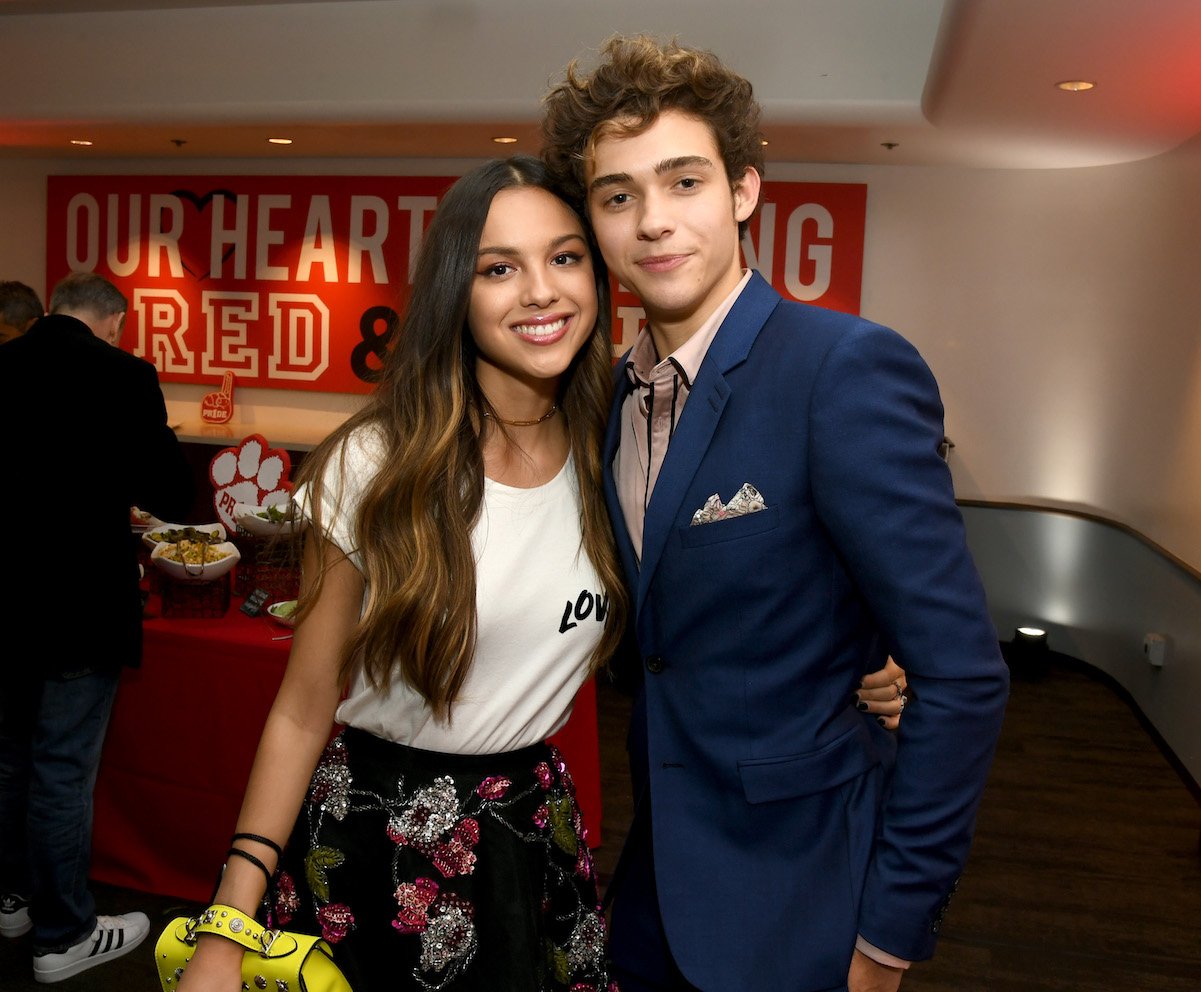 Joshua Bassett and Olivia Rodrigo pose with their arms around one another