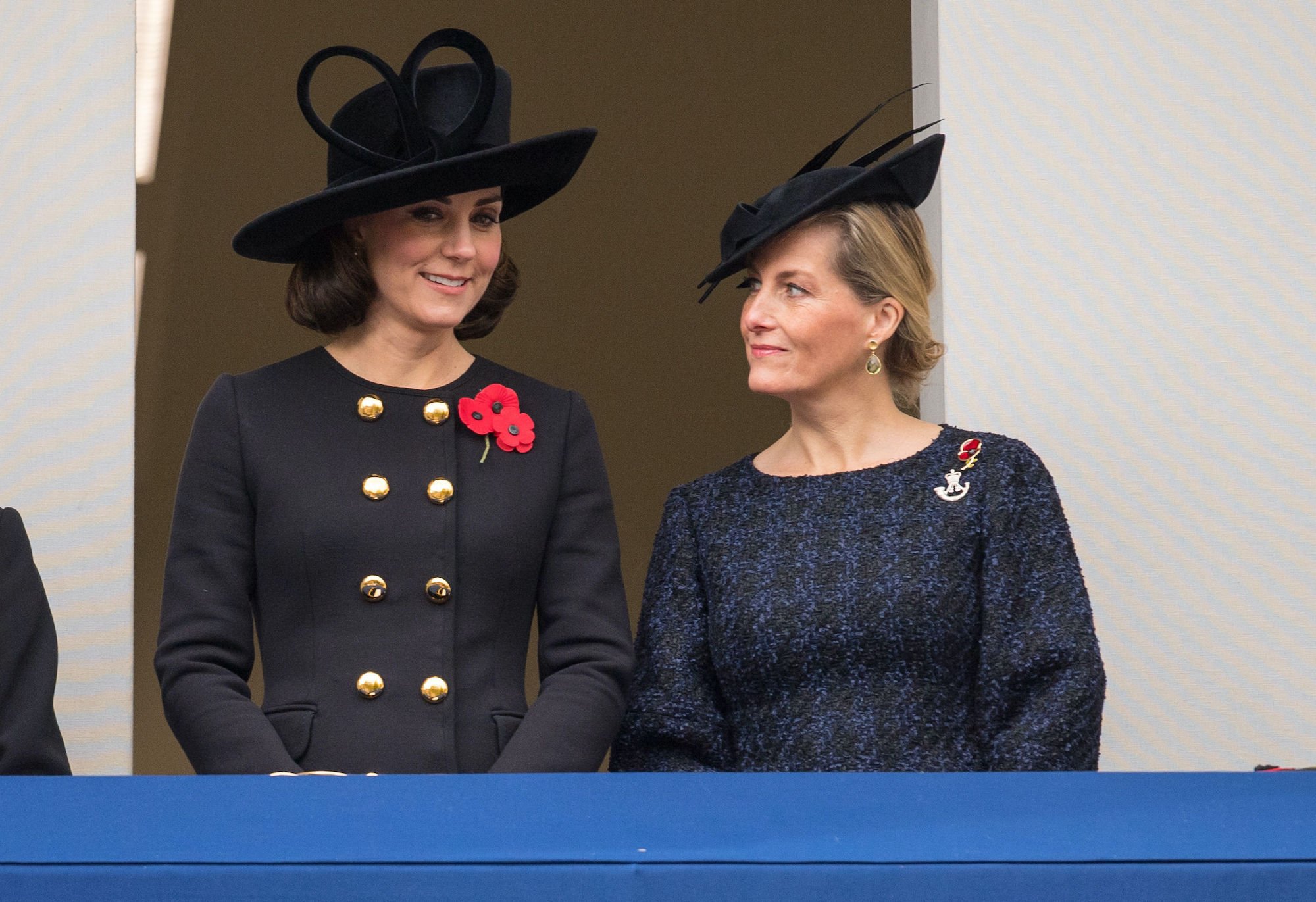 (L-R) Kate Middleton and Sophie, Countess of Wessex, smiling, looking down from a balcony