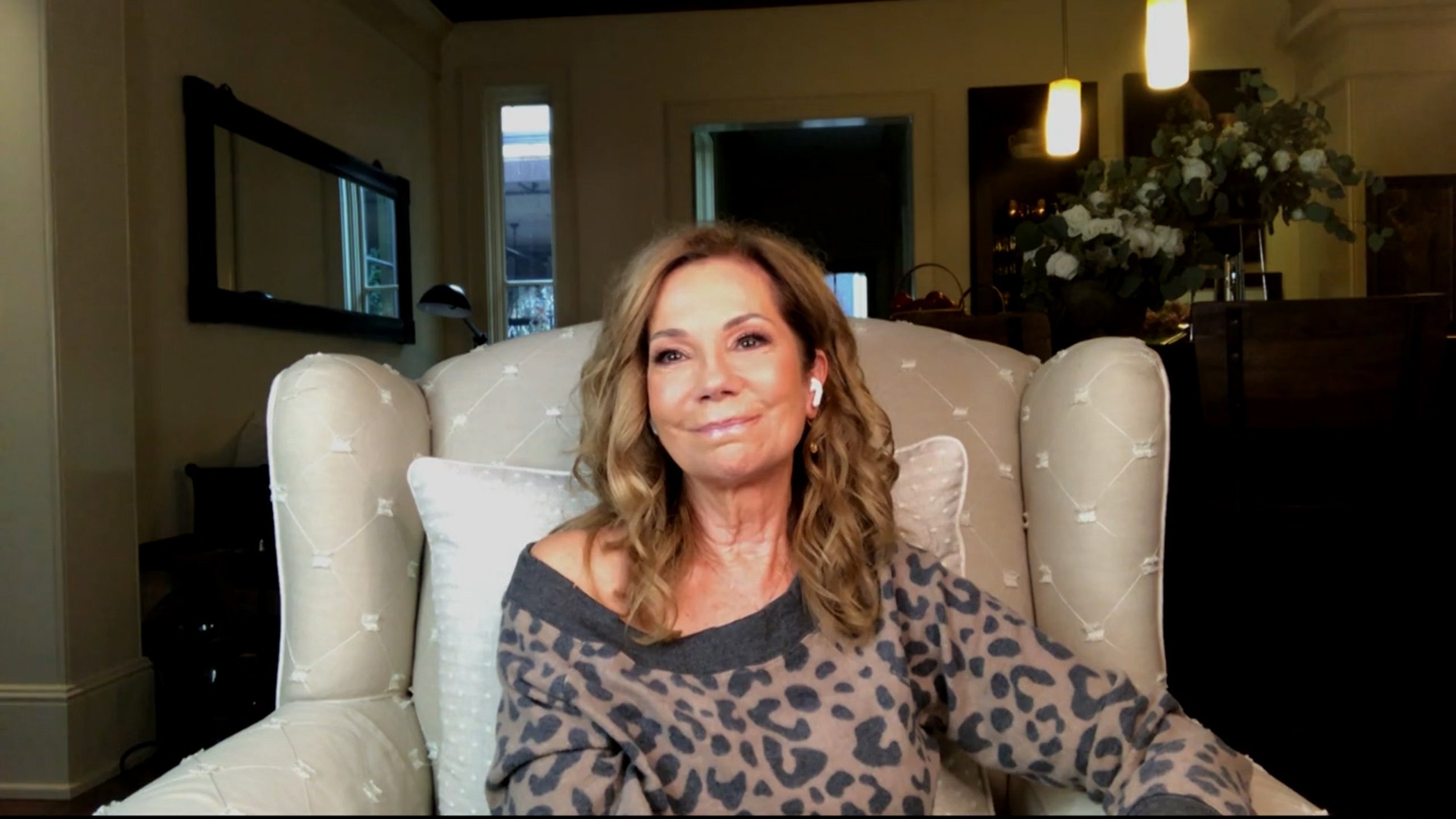 Kathie Lee Gifford in a spotted top sitting in a beige chair