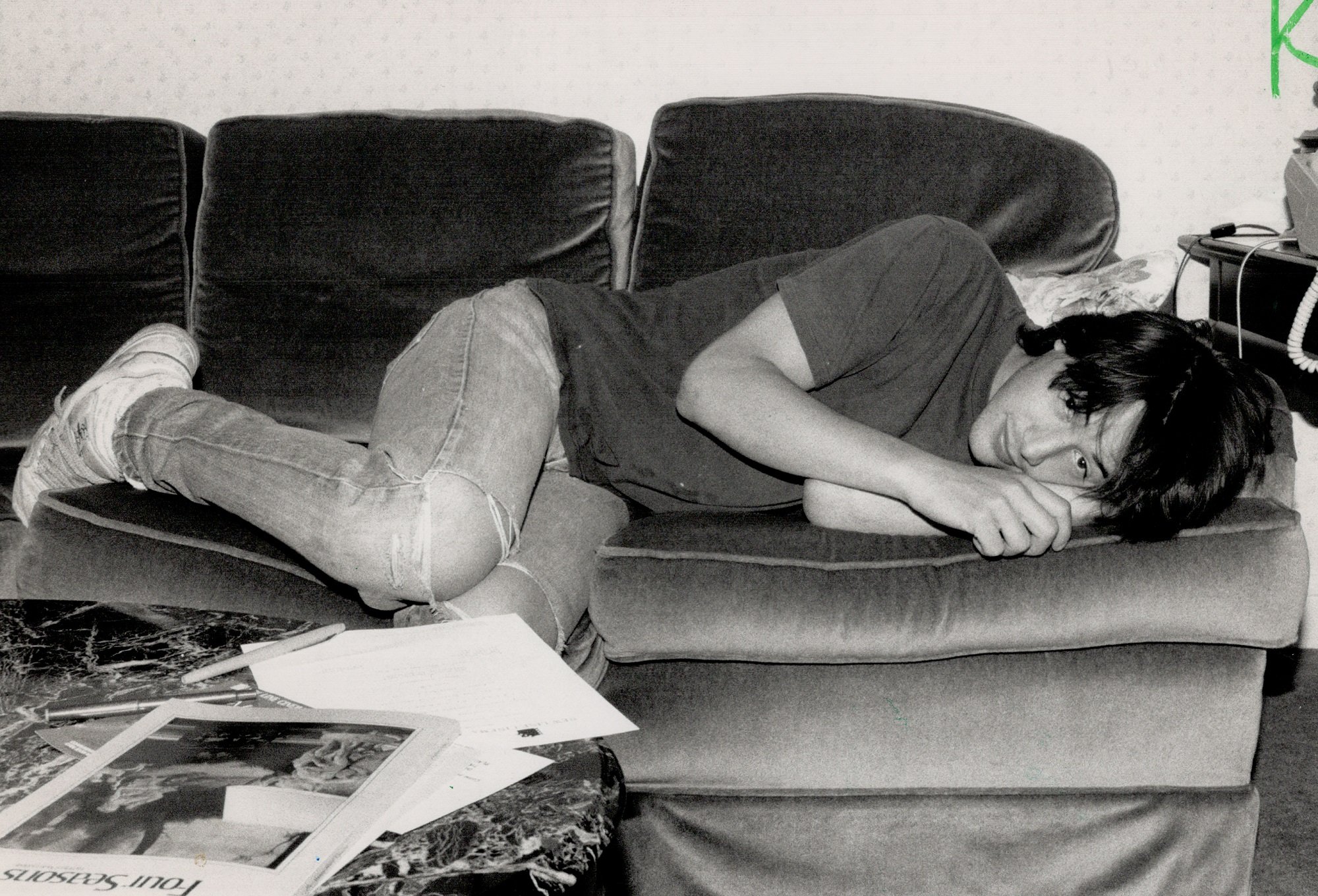 Keanu Reeves resting on a couch