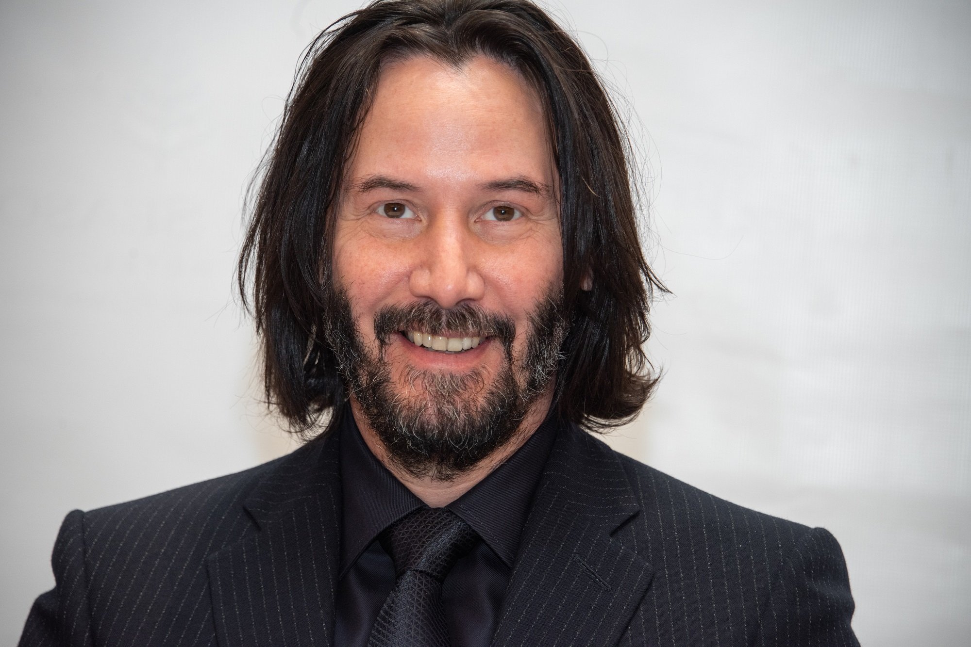 Keanu Reeves smiles at the John Wick 3 press conference