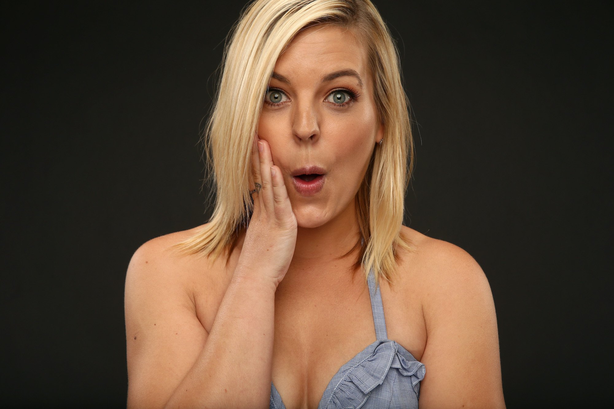 Kirsten Storms, looking surprised, holding her hand to her cheek