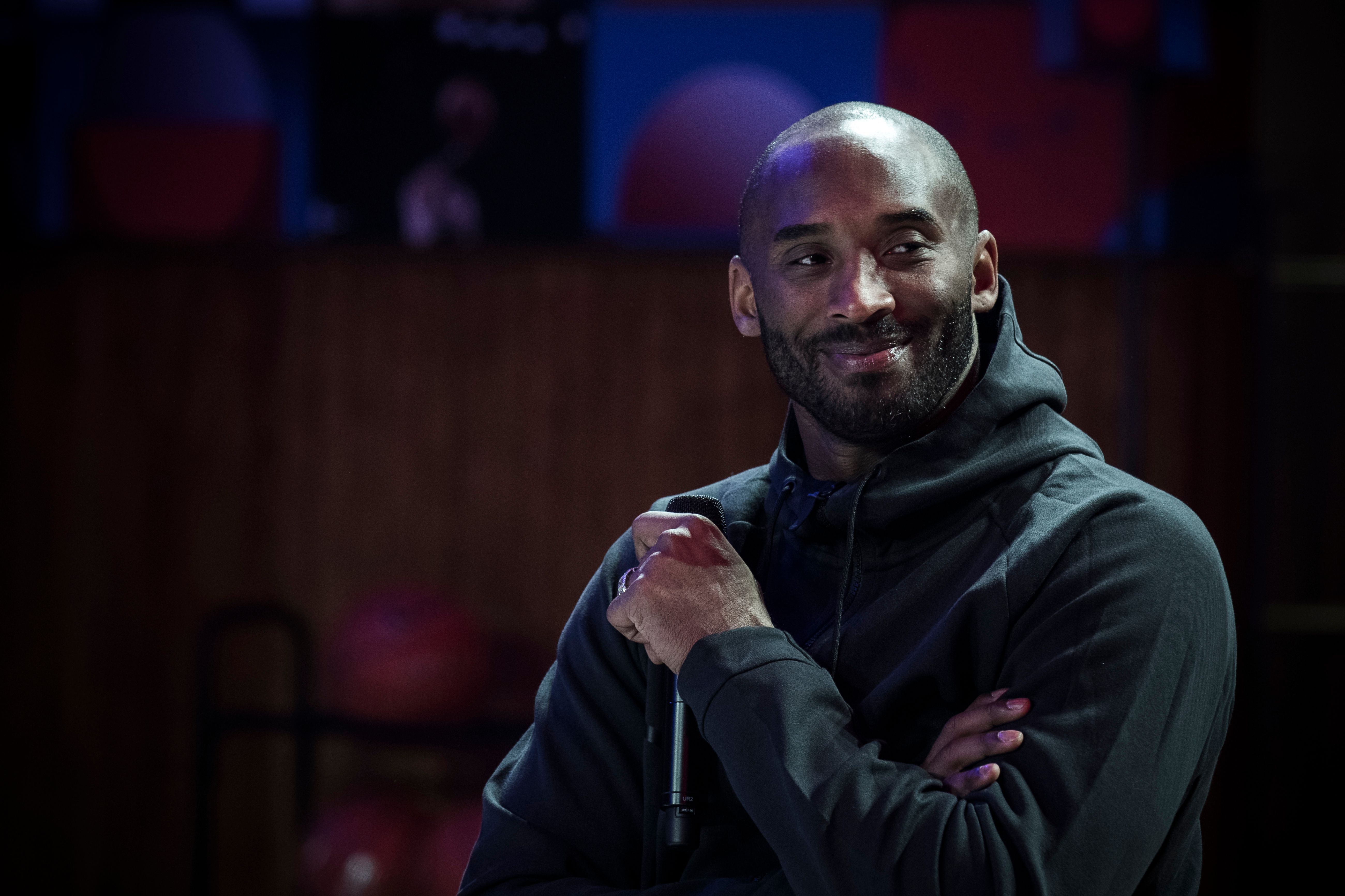 Late NBA player Kobe Bryant smiling at a promotional event organized by Nike