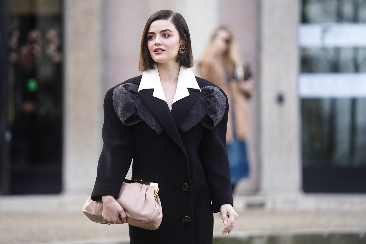 Lucy Hale in a black coat and tan hand bag spotted outside Paris
