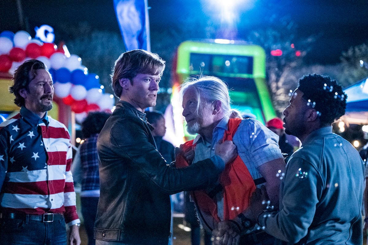 Mac grabs a man in an orange vest in scene from the show's series finale 