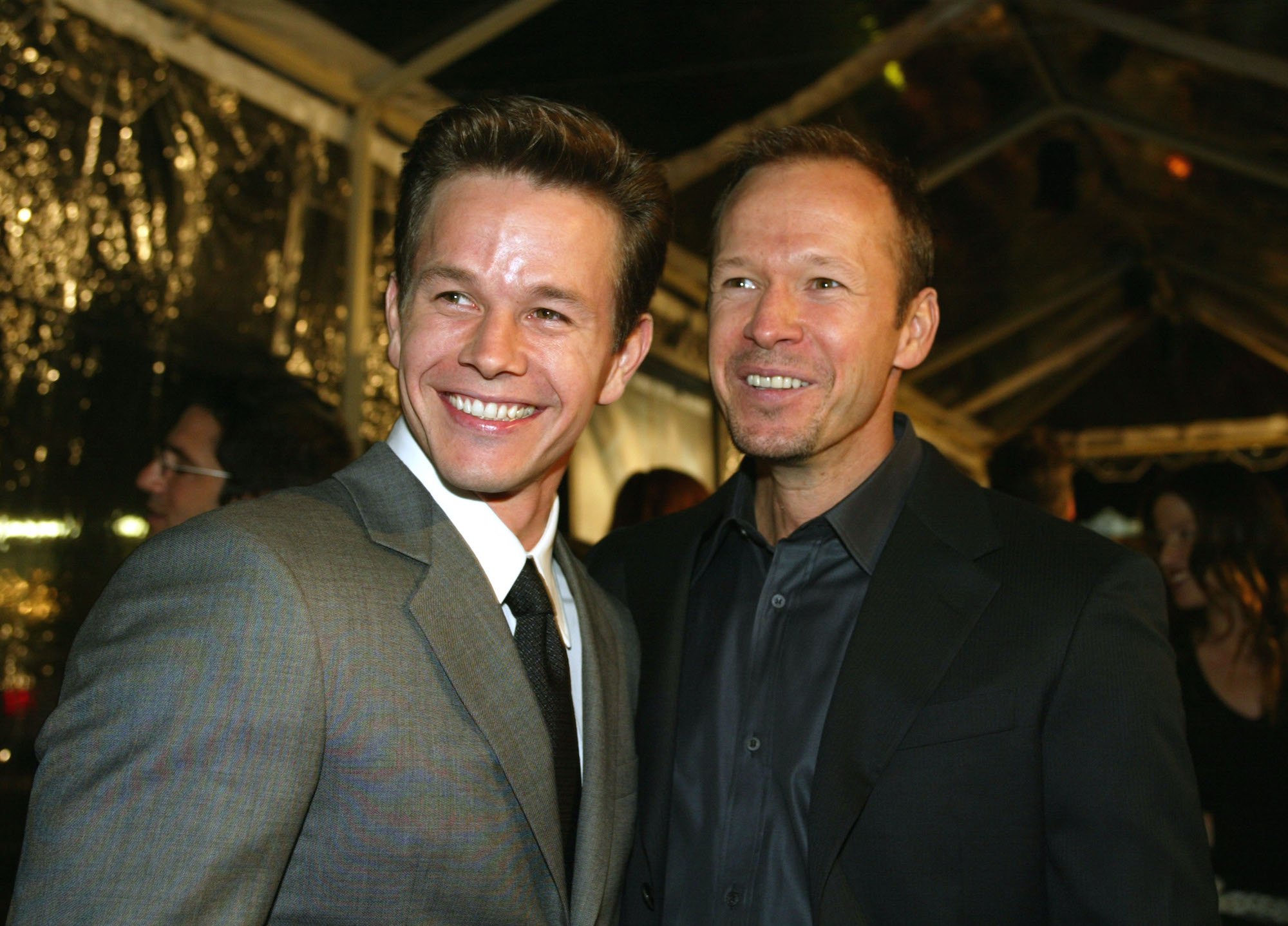 (L-R) Mark Wahlberg and Donnie Wahlberg smiling, looking to the left