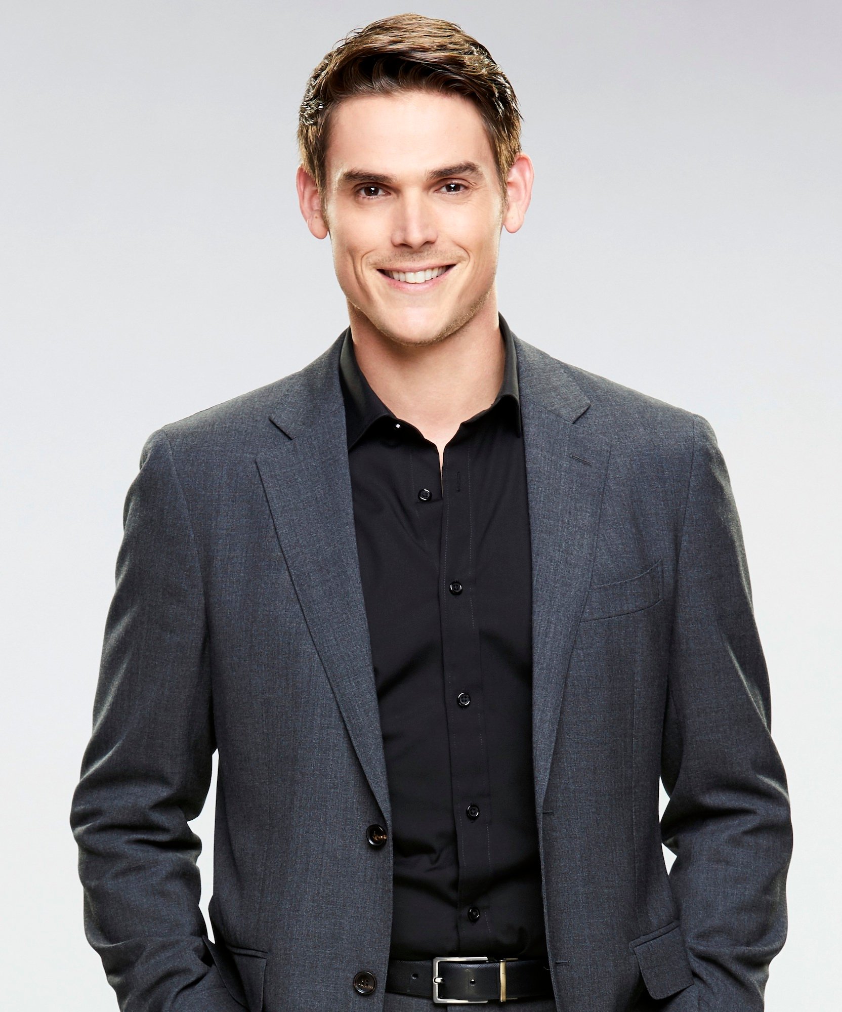 Mark Grossman smiling in front of a white background