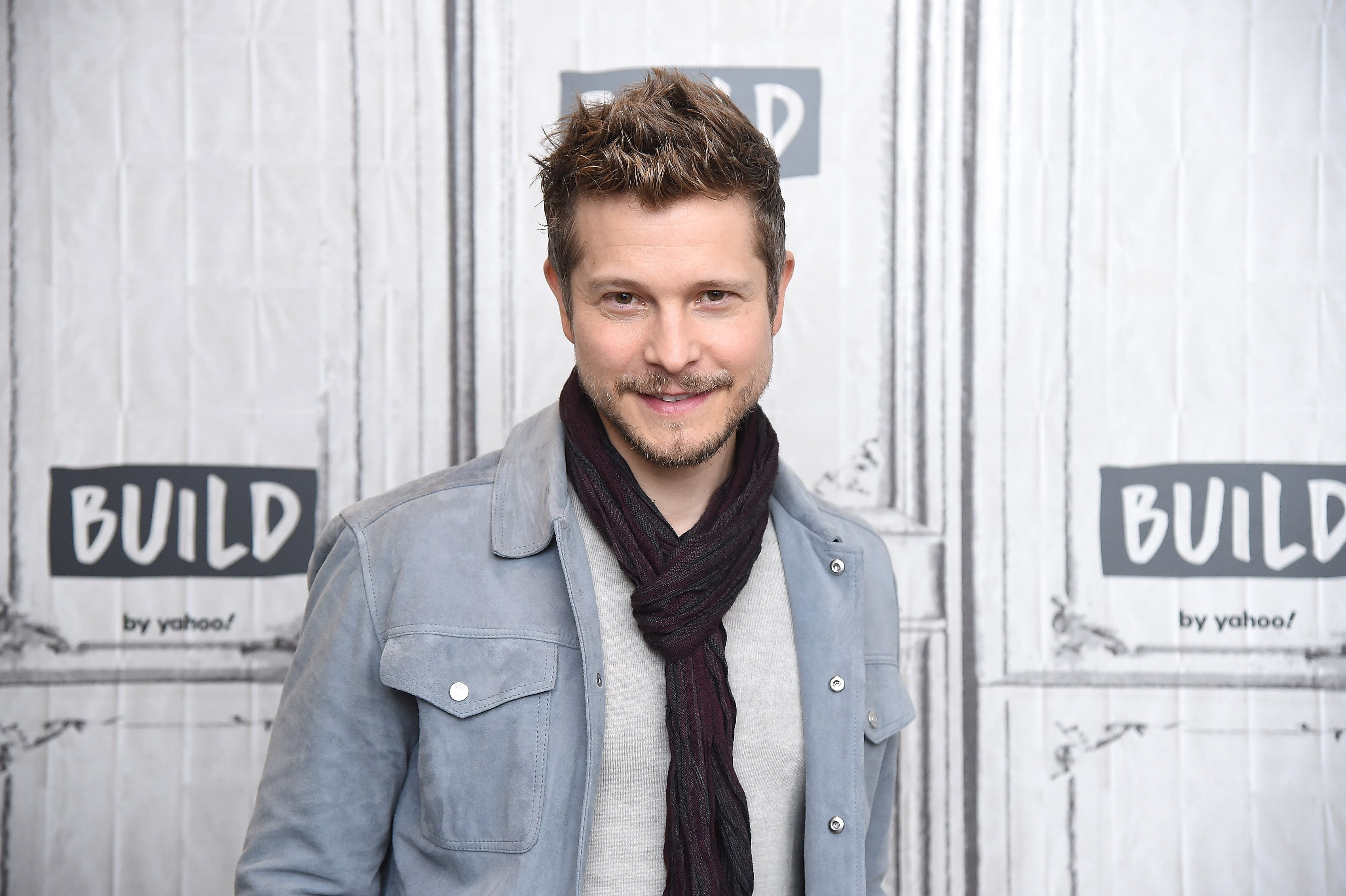 Matt Czuchry smiles for the cmaera as he visits Build Studio in New York City