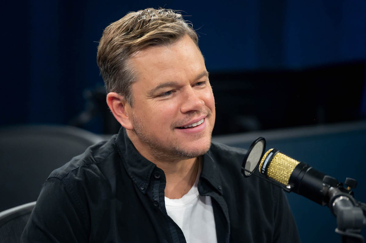 Matt Damon smiles as he speaks into a microphone during a visit to SiriusXM's Hollywood studios in 2019