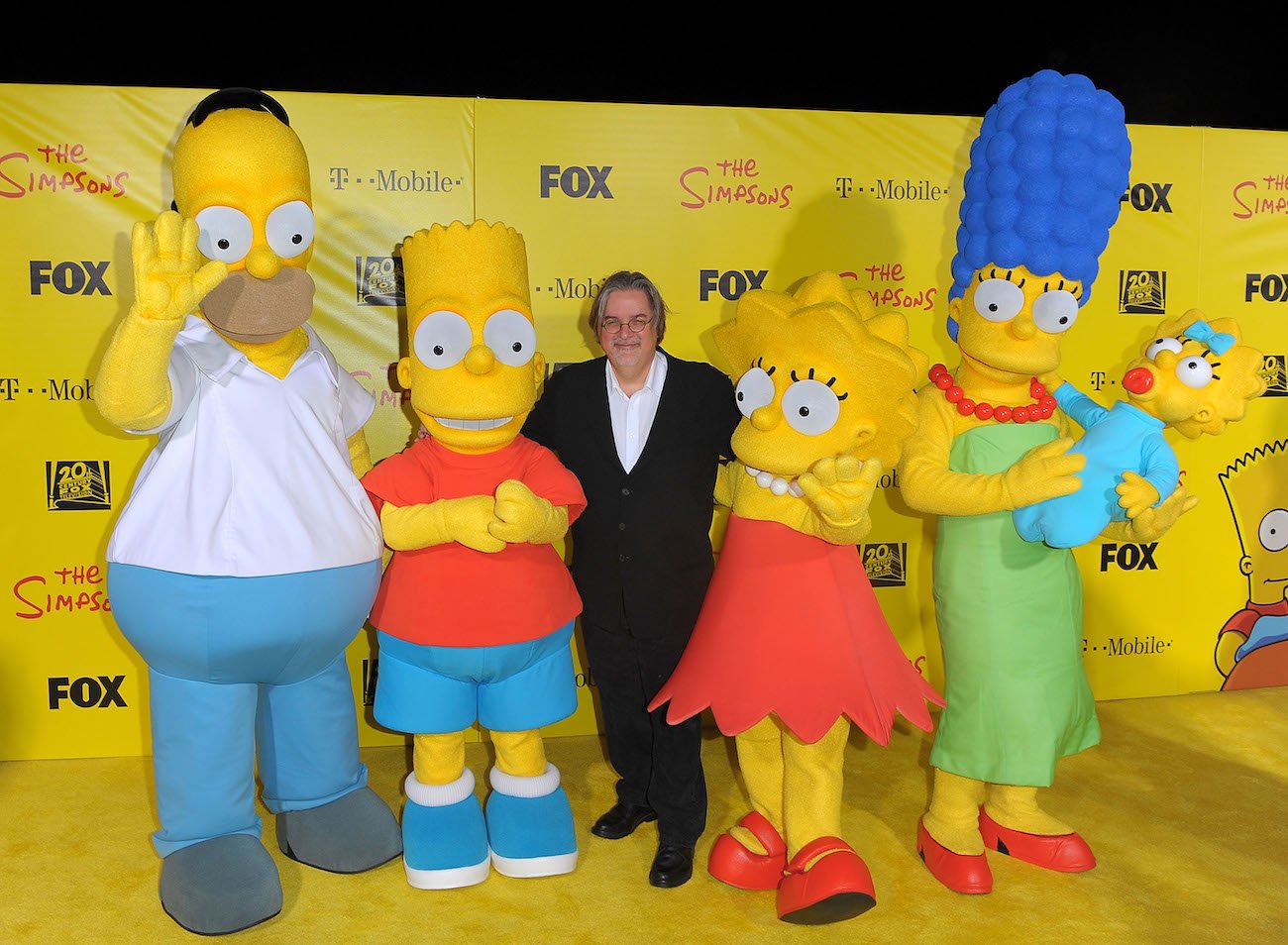 Matt Groening posing with characters of The Simpsons