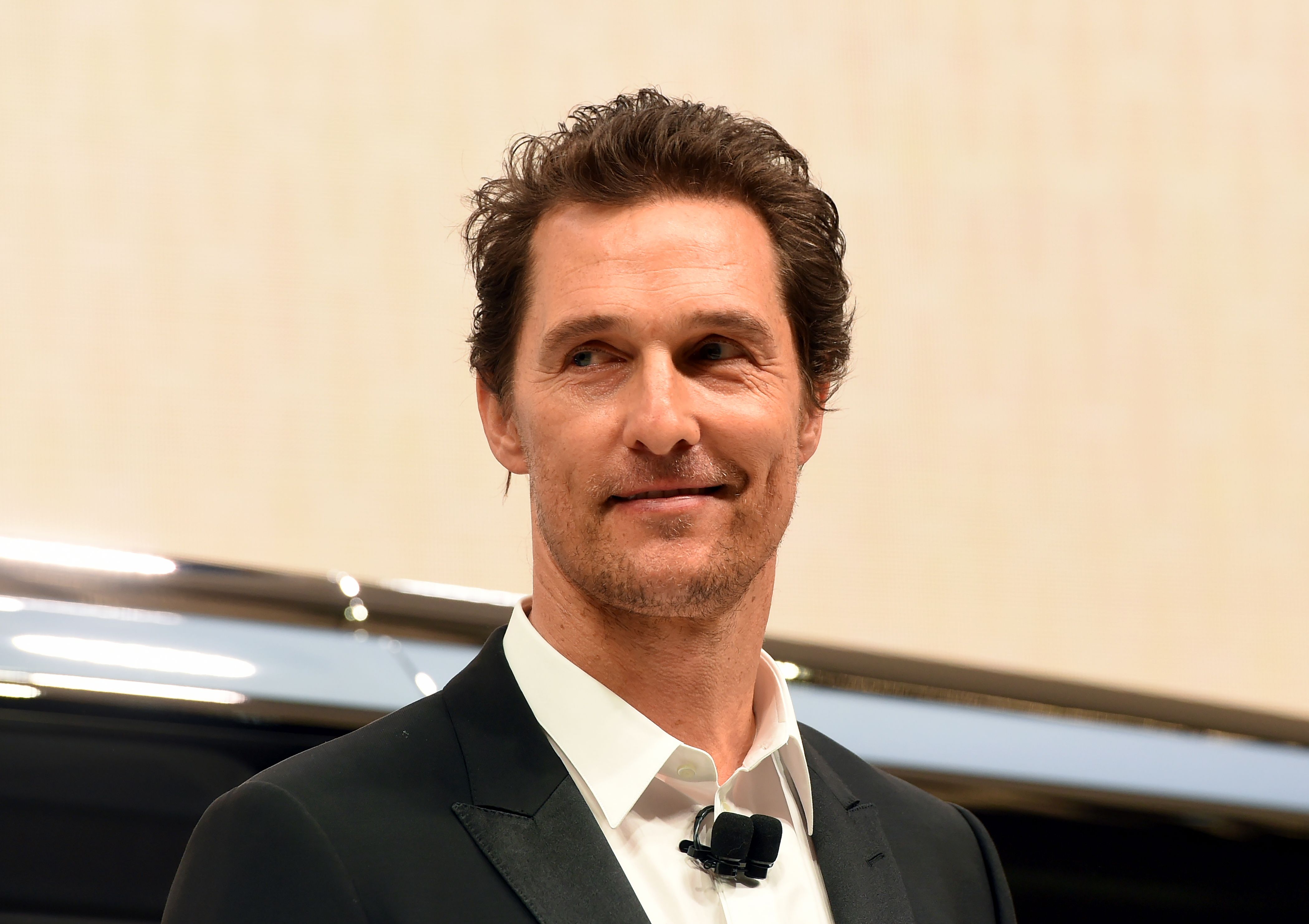 Matthew McConaughey smiles at an auto show