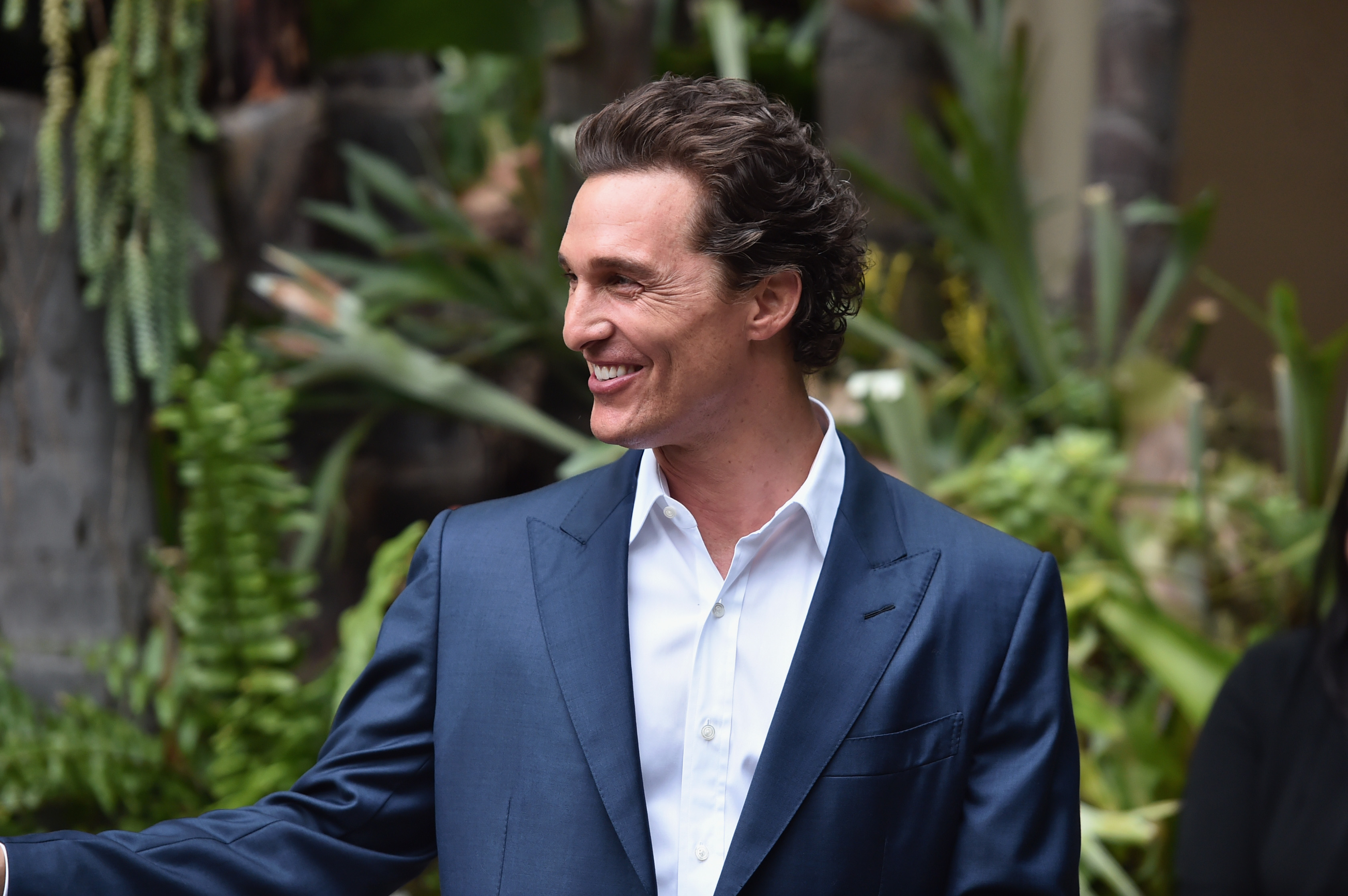 Matthew McConaughey smiles in a blue suit