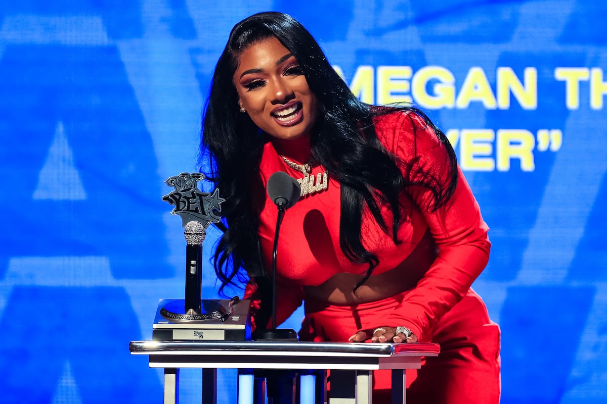 Megan Thee Stallion speaks onstage at the BET Hip Hop Awards wearing red