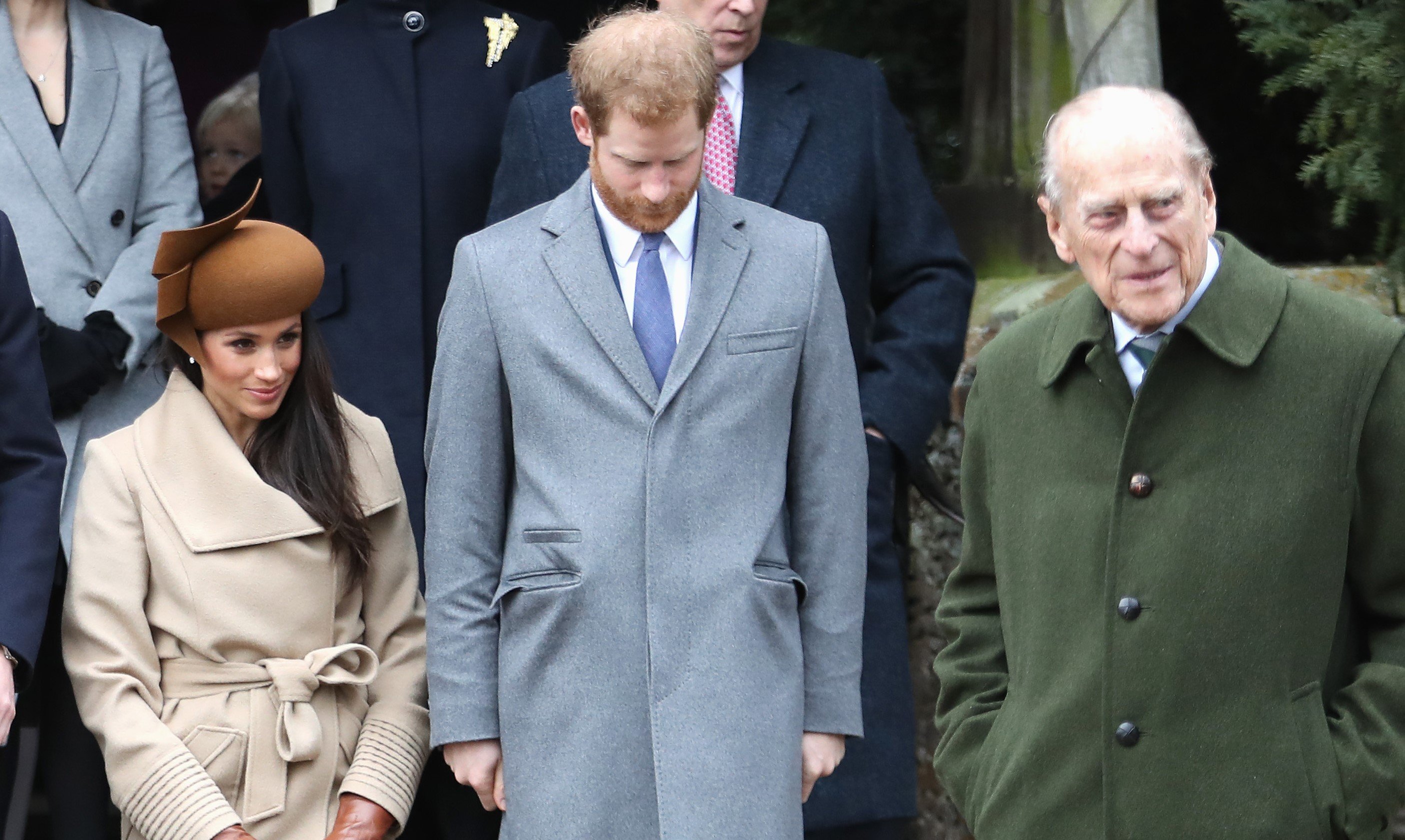 Meghan Markle, Prince Harry, and Prince Philip standing outside Church of St Mary Magdalene following Christmas Day Service in 2017