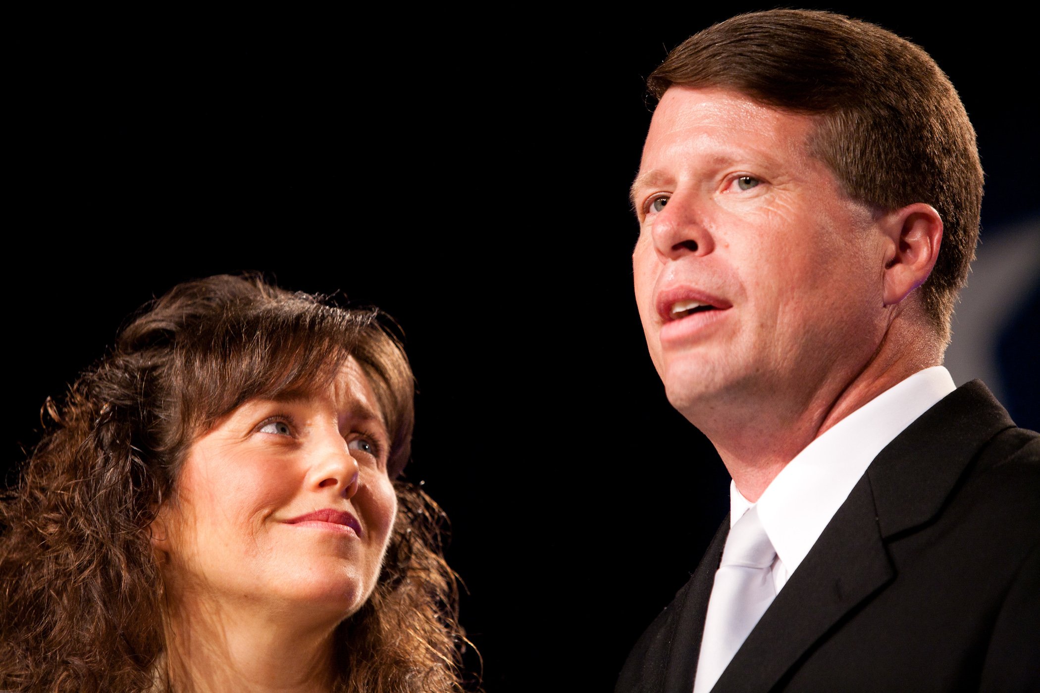 Michelle Duggar of the Duggar family from TLC's 'Counting On' looking up at Jim Bob Duggar against a black background