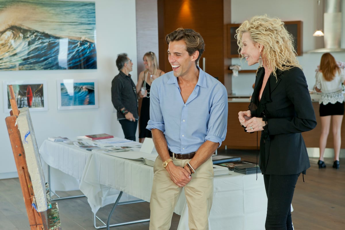 Madison Hildebrand and a blonde woman smile and laughing on Million Dollar Listing Los Angeles