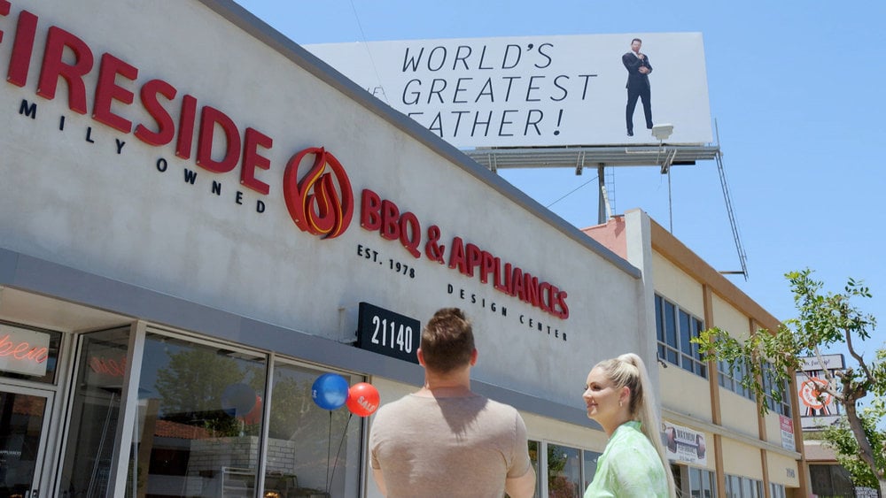 Mike and Maryse Mizanin from Miz & Mrs. looking at a billboard 