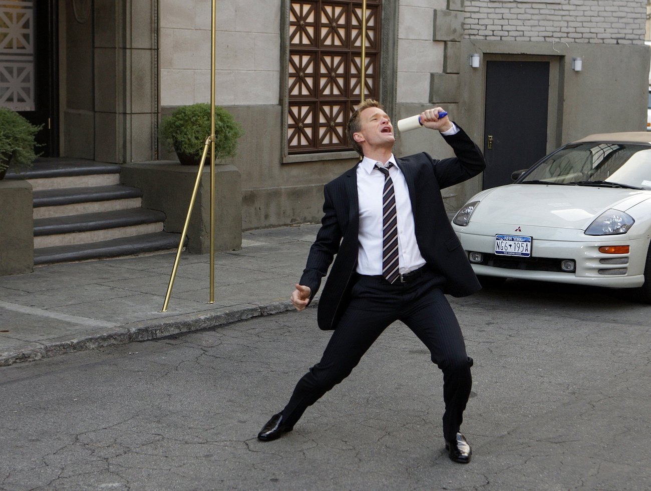 Neil Patrick Harris as Barney Stinson, singing in the street