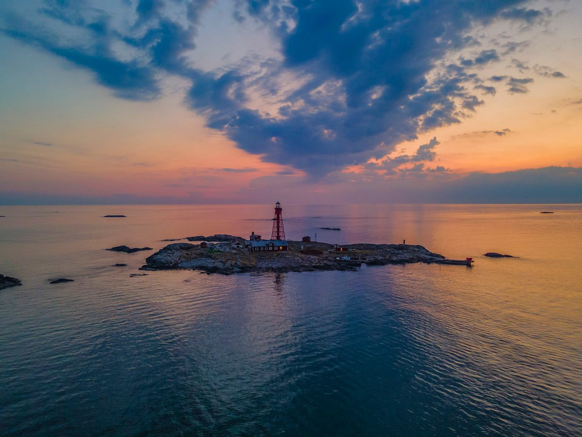 Lighthouse on an island at sunset