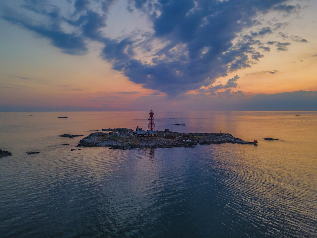 Lighthouse on an island at sunset