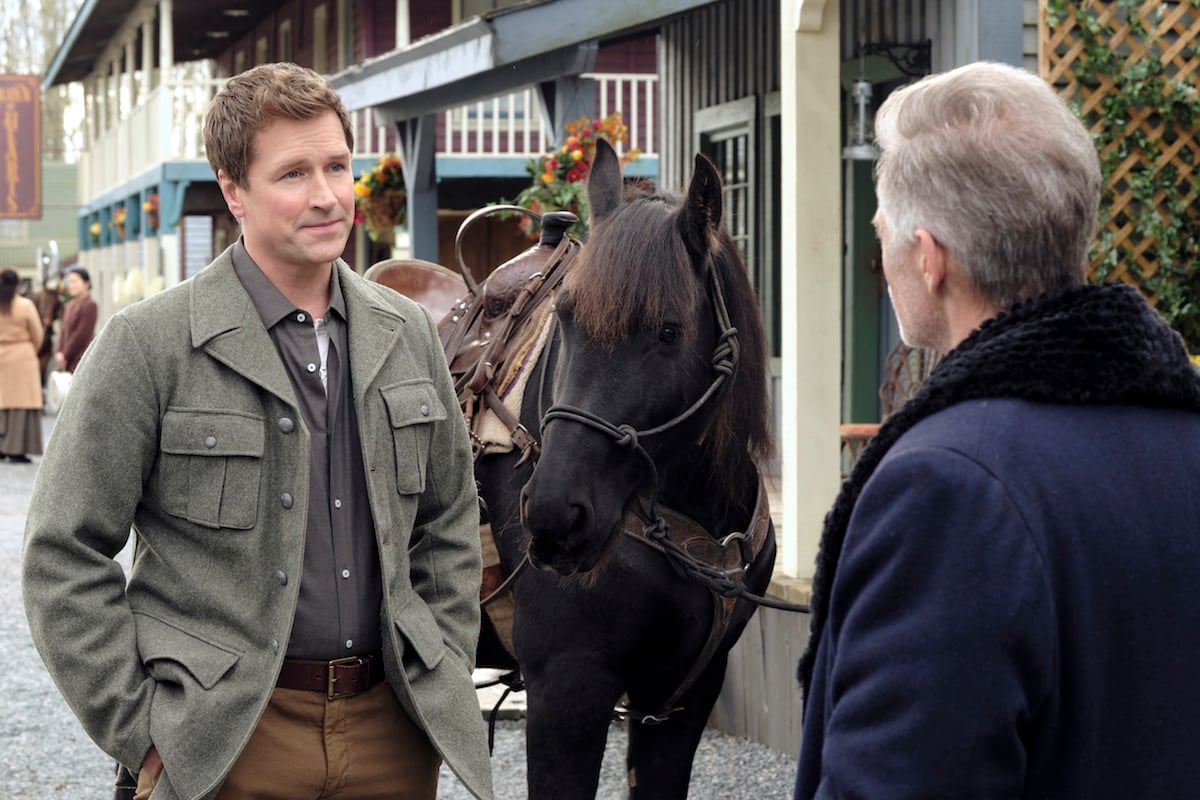Carson Shepherd standing next to a horse in episode of When Calls the Heart