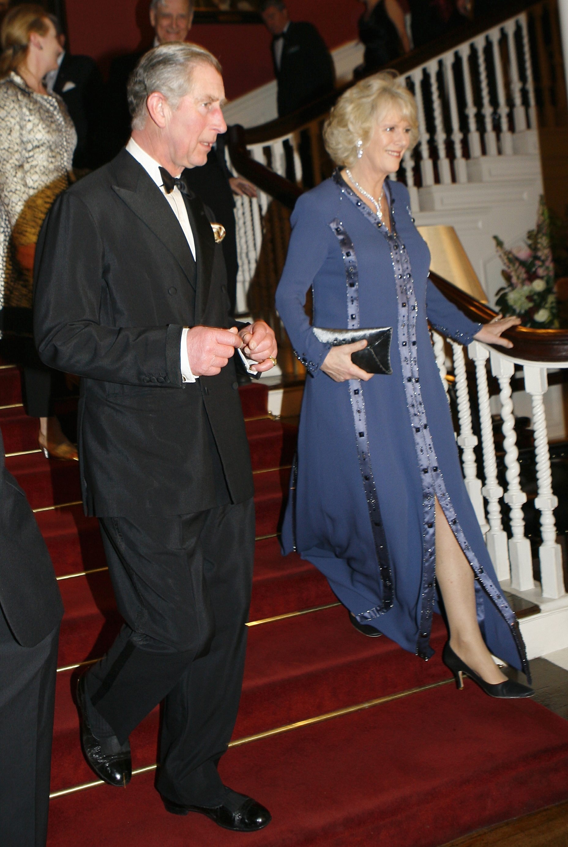 Prince Charles and Camilla Parker Bowles wallking down stairs at a Global Enviornmental Citizen Award dinner in New York