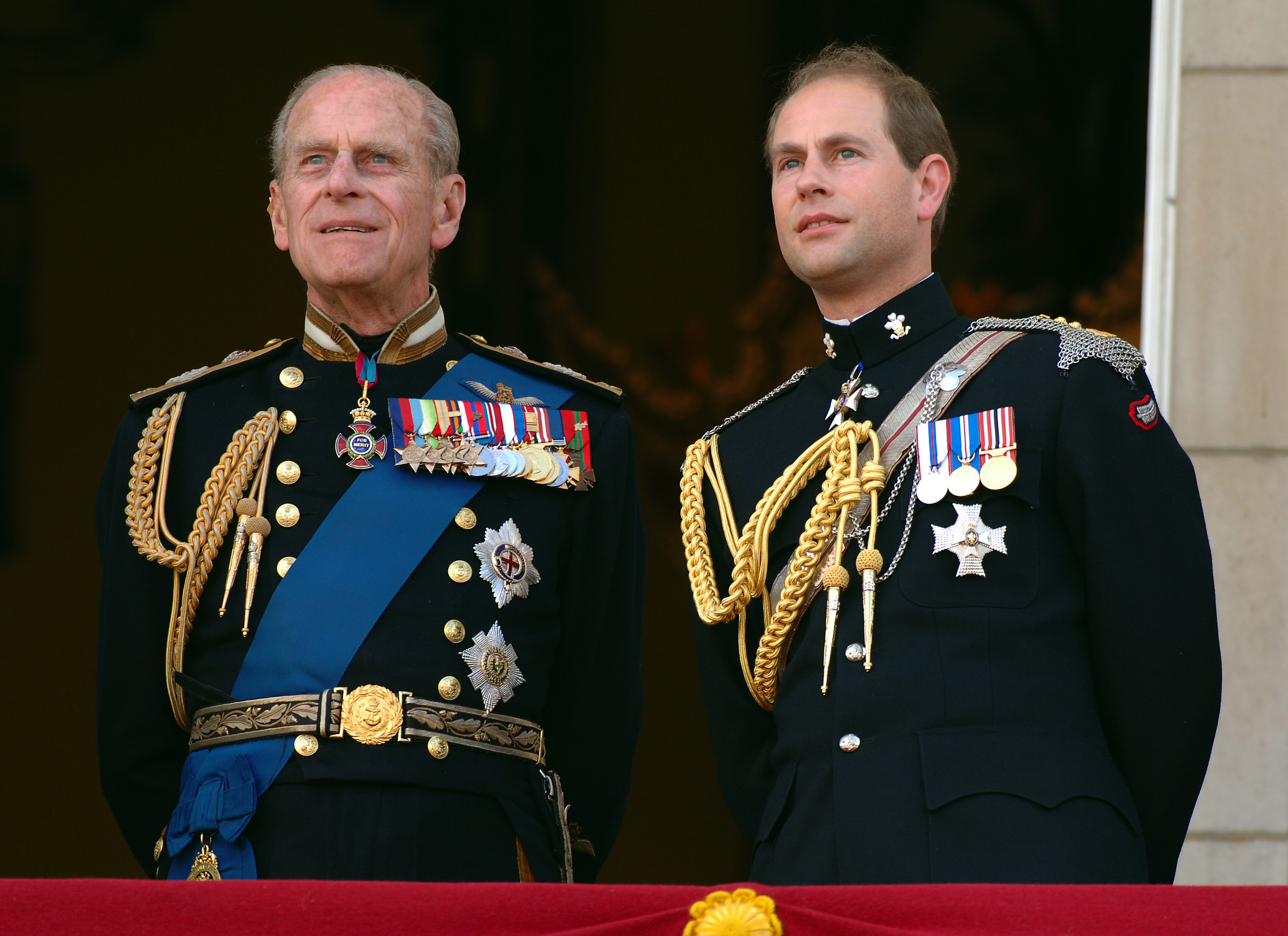 Prince Edward and Prince Philp dressed in their military uniforms as they watch the flypast over the Mall of British and US World War II aircraft from the balcony of Buckingham Palace