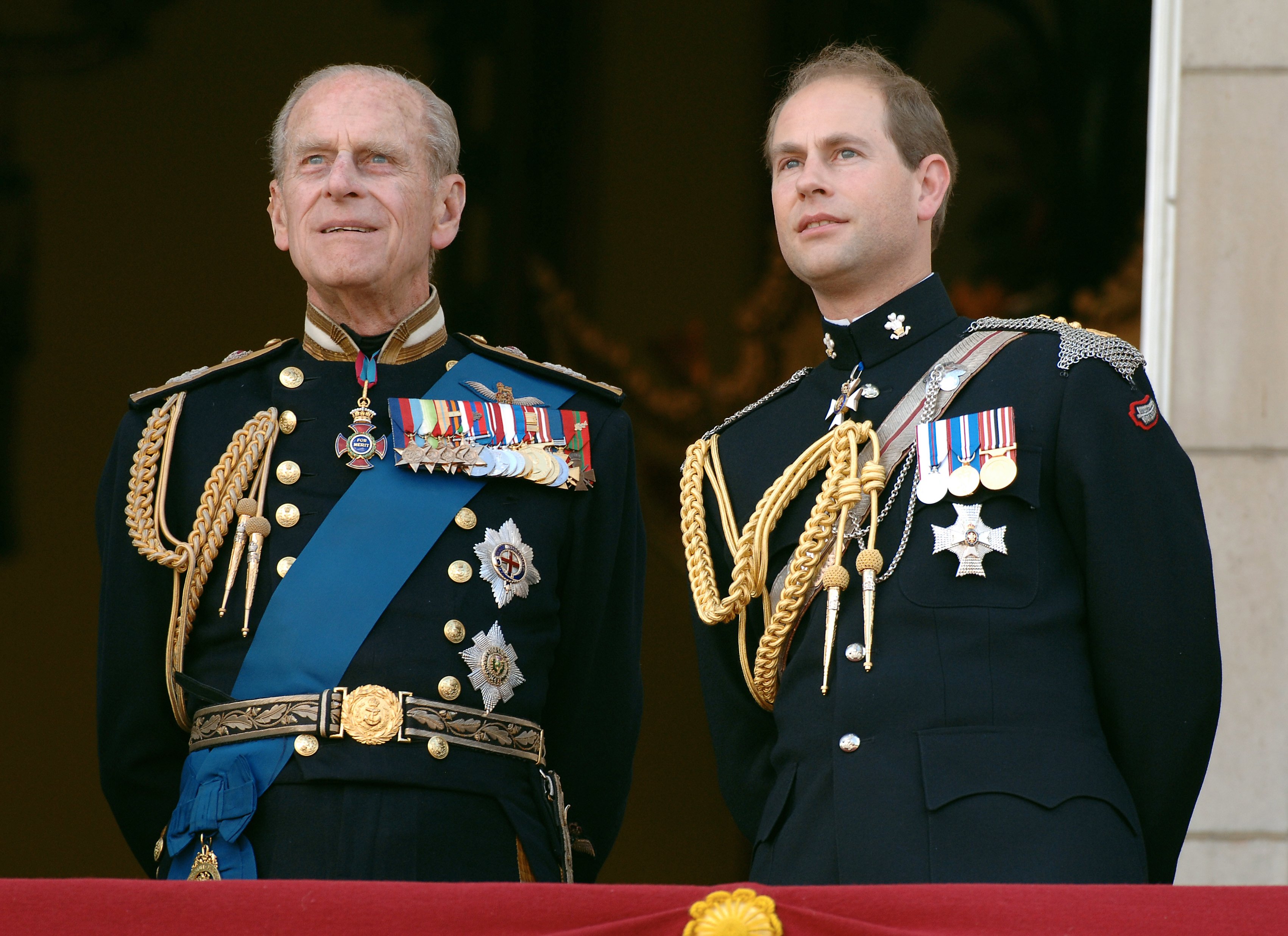 Prince Edward and Prince Philp dressed in their military uniforms as they watch the flypast over the Mall of British and US World War II aircraft from the balcony of Buckingham Palace 