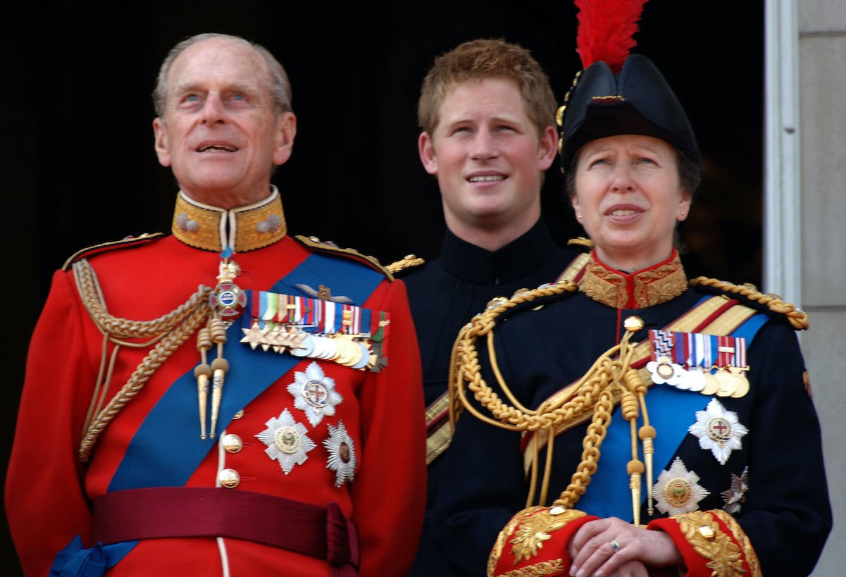 Prince Philip, Prince Harry, and Princess Anne stand on the balcony of Buckingham Palace in 2006