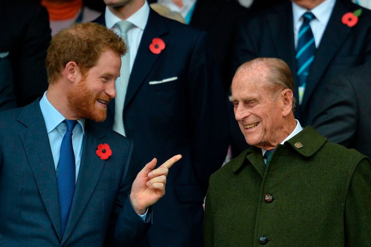 Prince Harry speaks with his grandfather Prince Philip