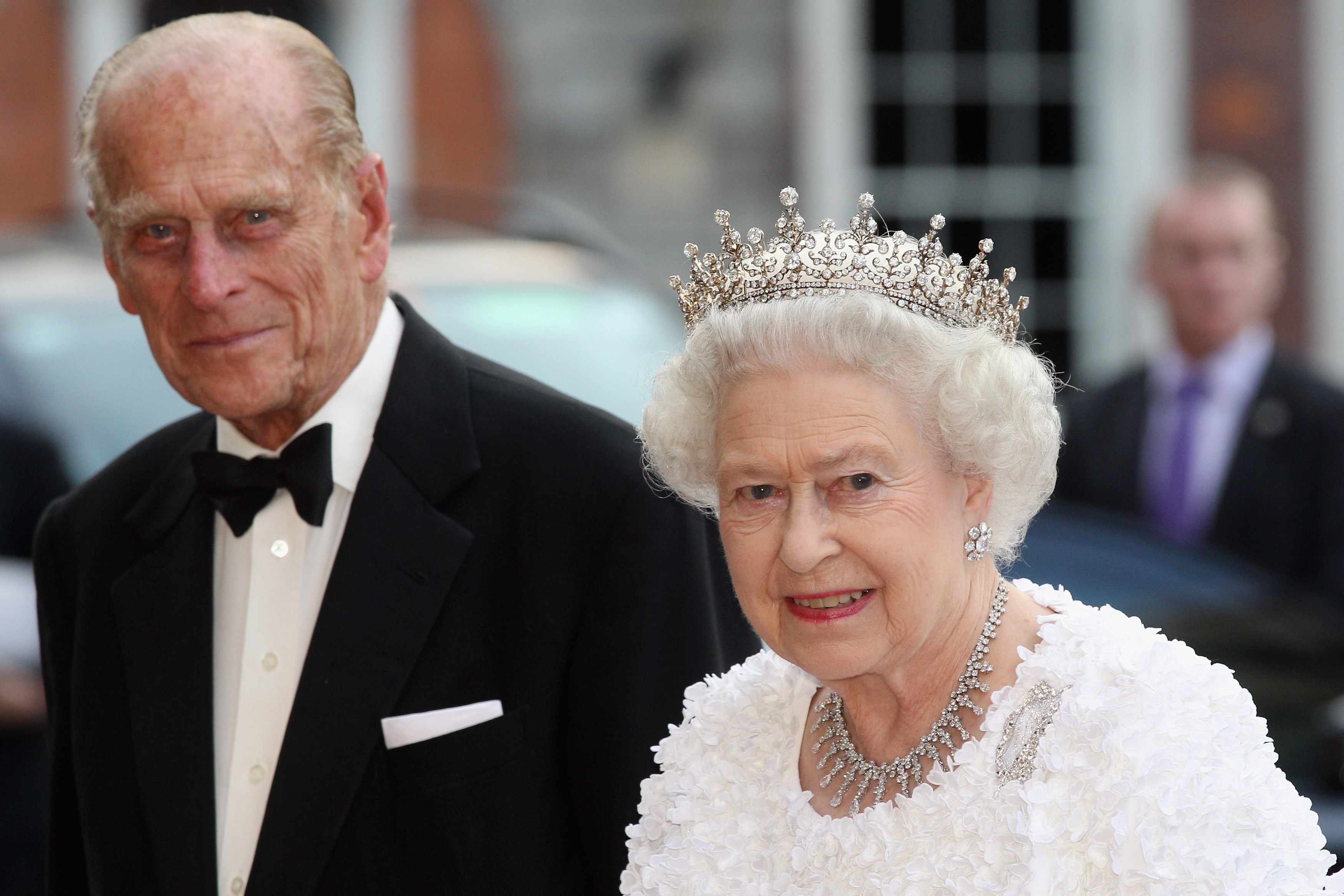 Prince Philip in a tuxedo and Queen Elizabeth in a white gown and tiara as they attend state banquet in Dublin