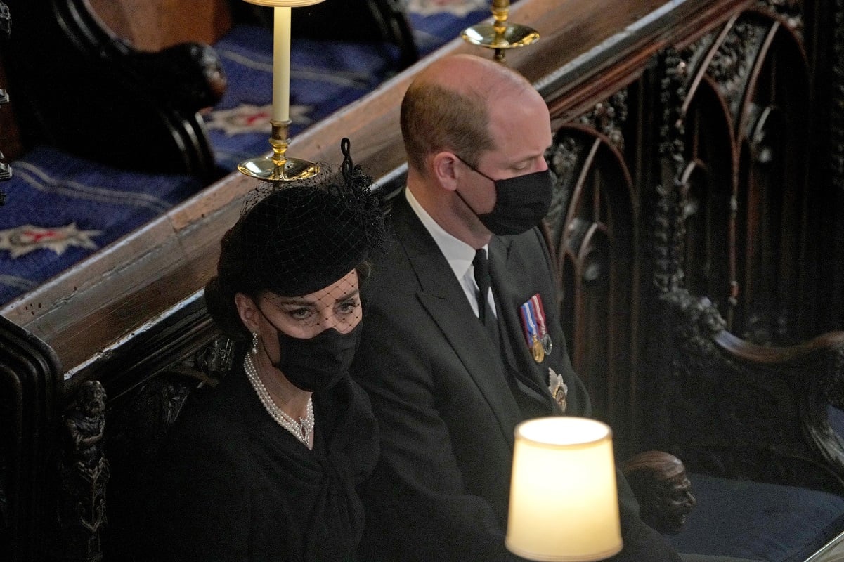 Prince William and Kate Middleton sitting next to each other in church during  Prince Philip's funeral service