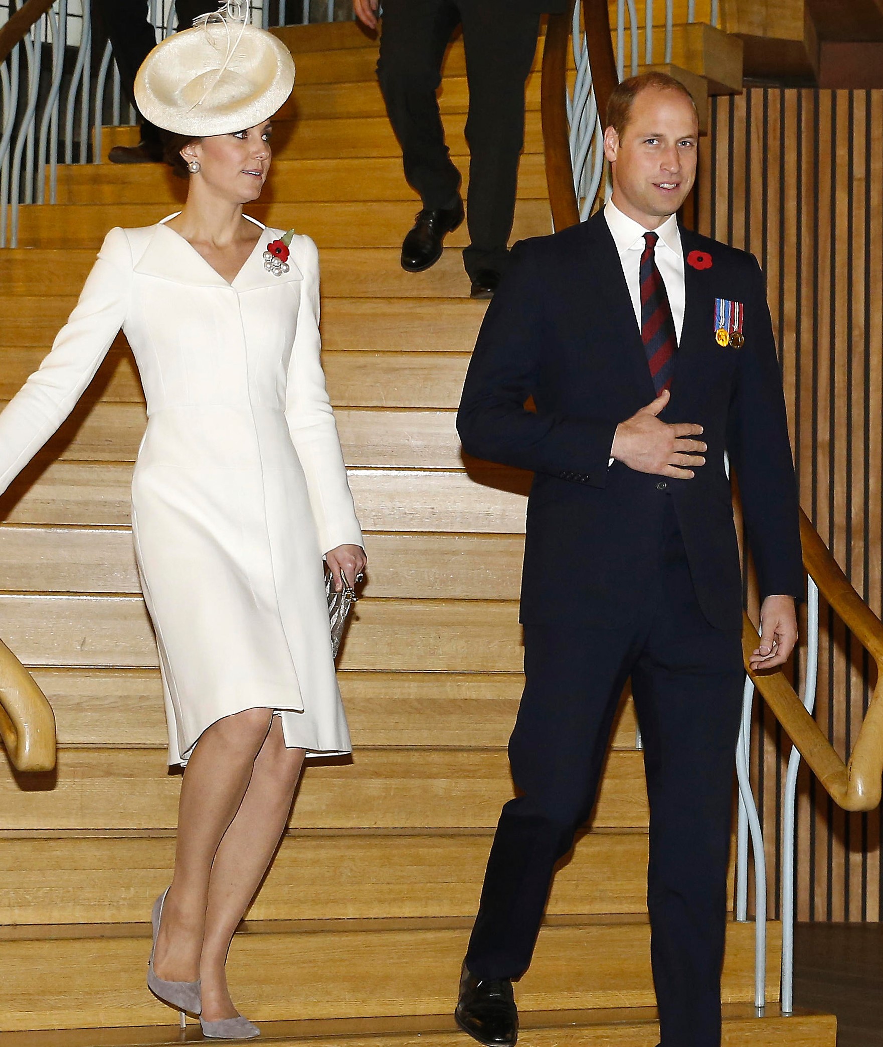 Prince William and Kate Middleton walking side by side down flight of stairs at event in 2017