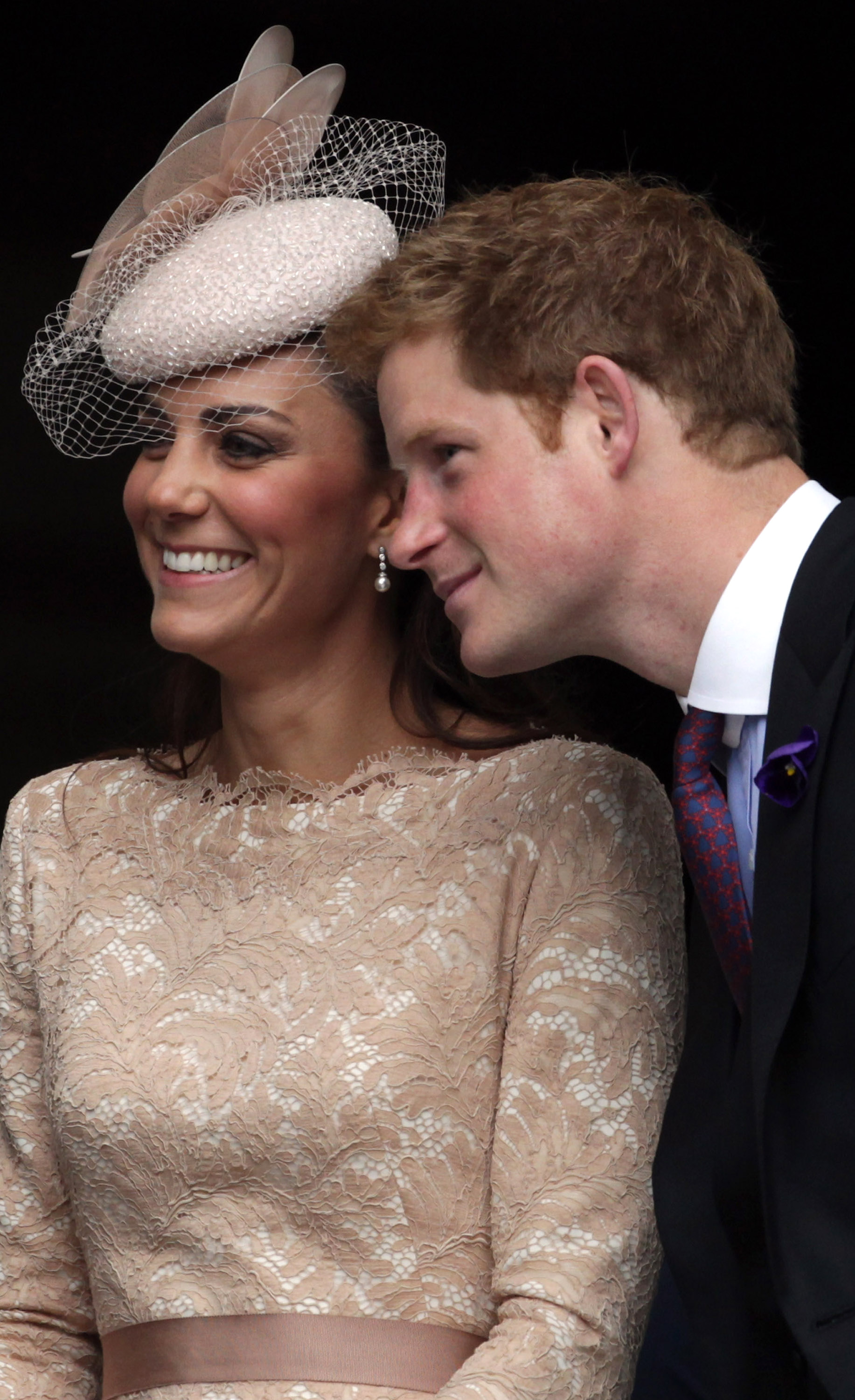 Prince leaning over Kate Middleton's shoulder to get in a photo