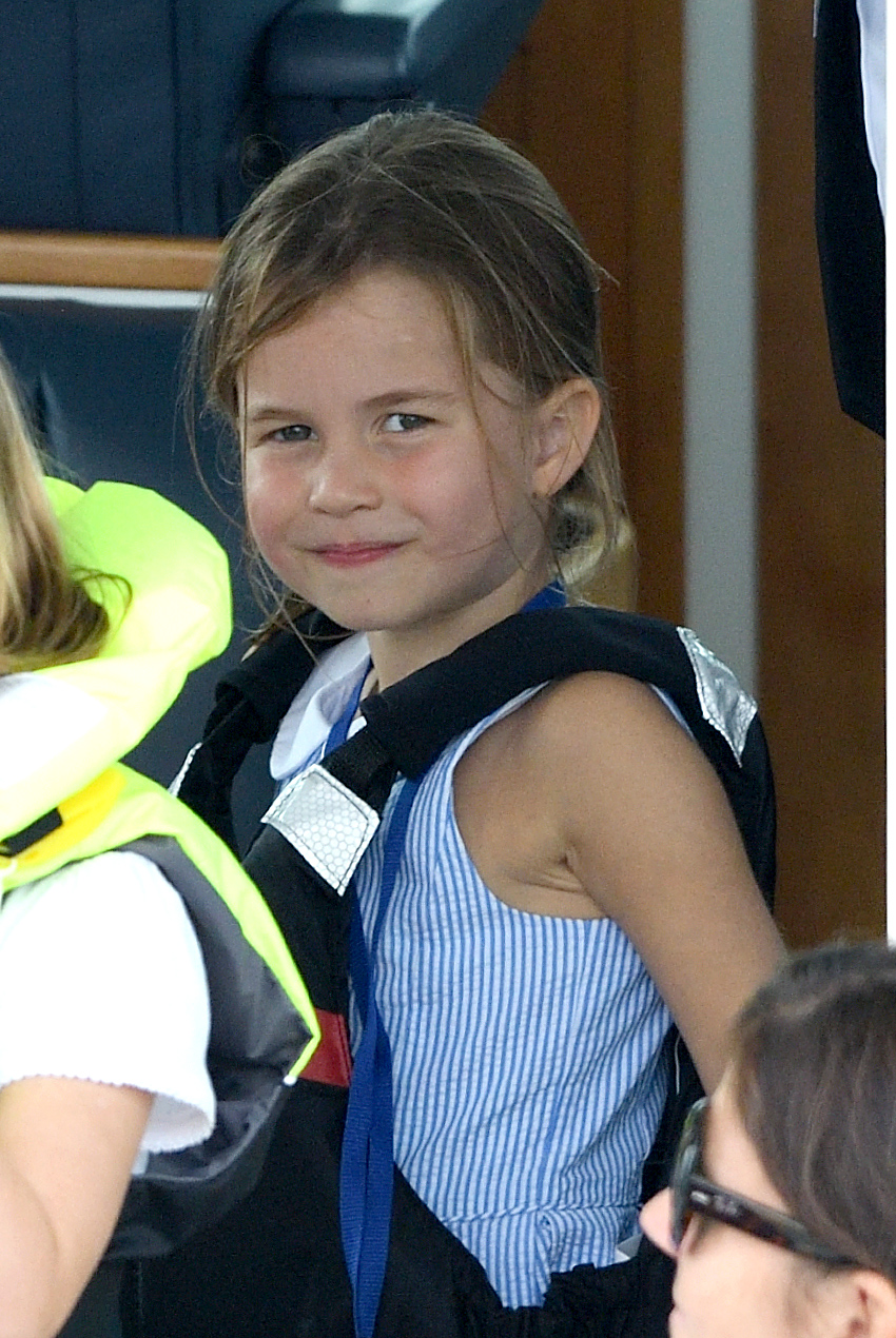 Princess Charlotte seated at the King's Cup Regatta in a pin-striped outfit Duke And Duchess Of Cambridge Take Part In The King's Cup Regatta