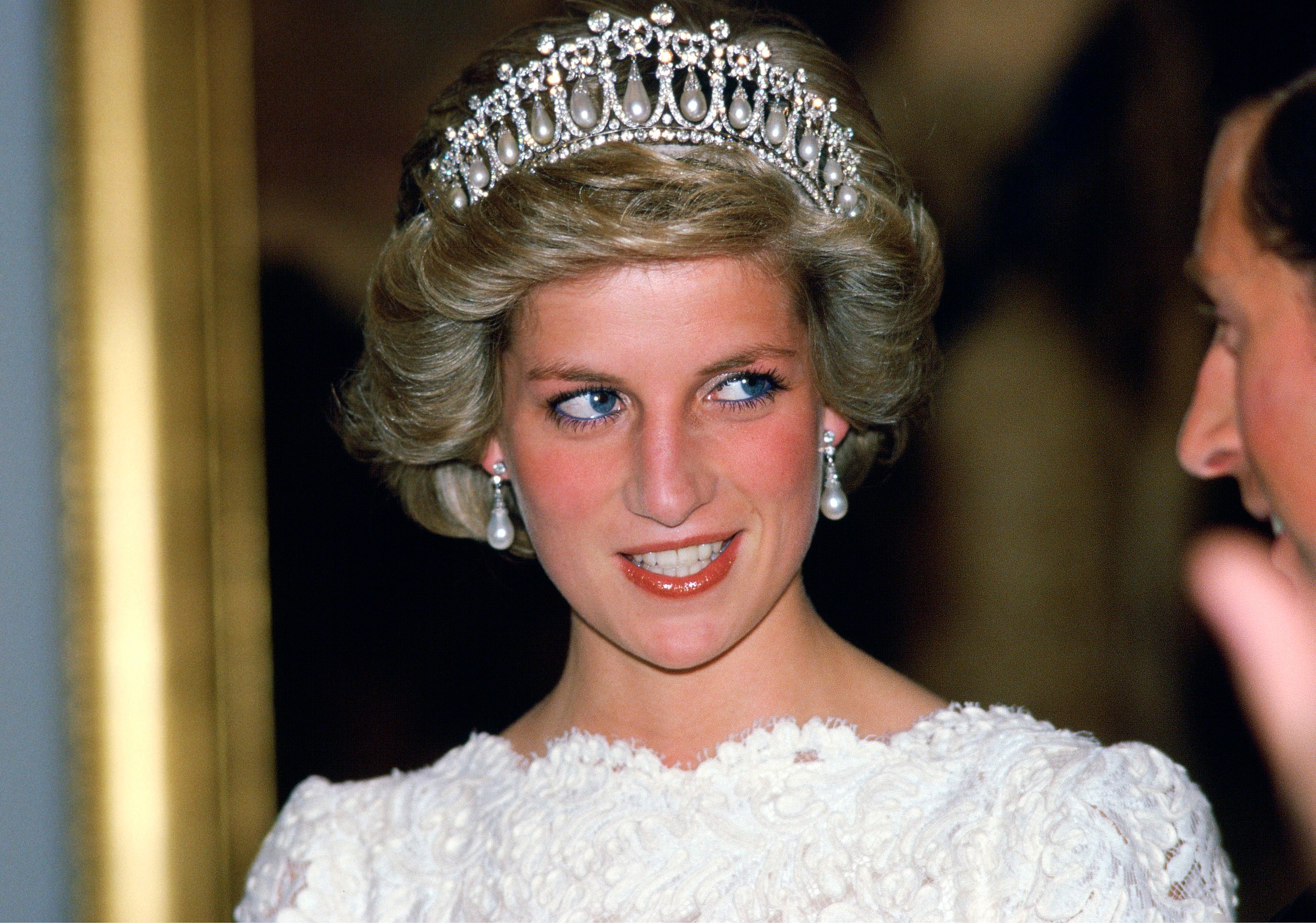 Princess Diana donning Queen Mary's Diamond And Pearl Tiara while having a conversation with Prince Charles